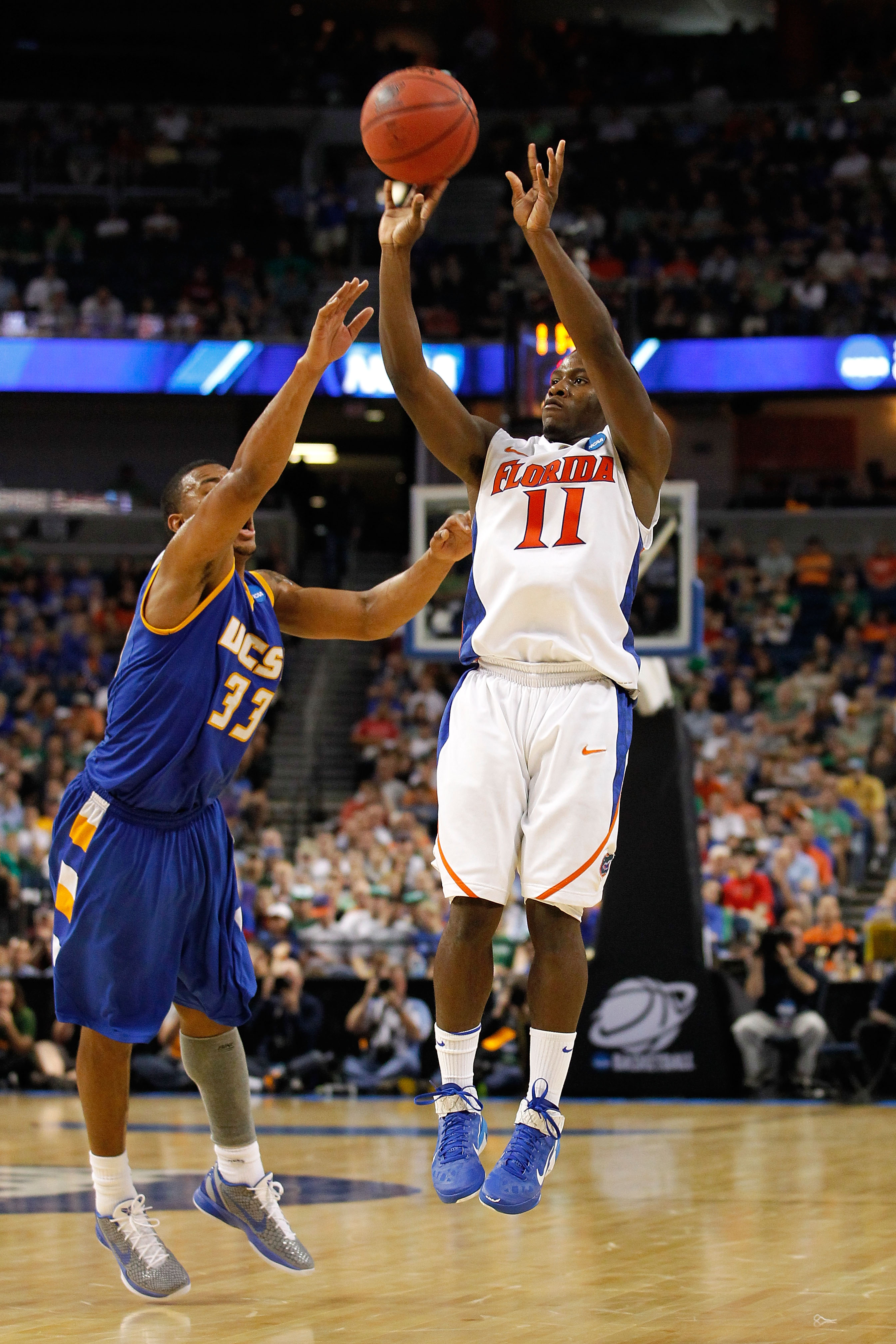 TAMPA, FL - MARCH 17: Erving Walker #11 of the Florida Gators attempts a shot against Orlando Johnson #33 of the UC Santa Barbara Gauchos sduring the second round of the 2011 NCAA men's basketball tournament at St. Pete Times Forum on March 17, 2011 in