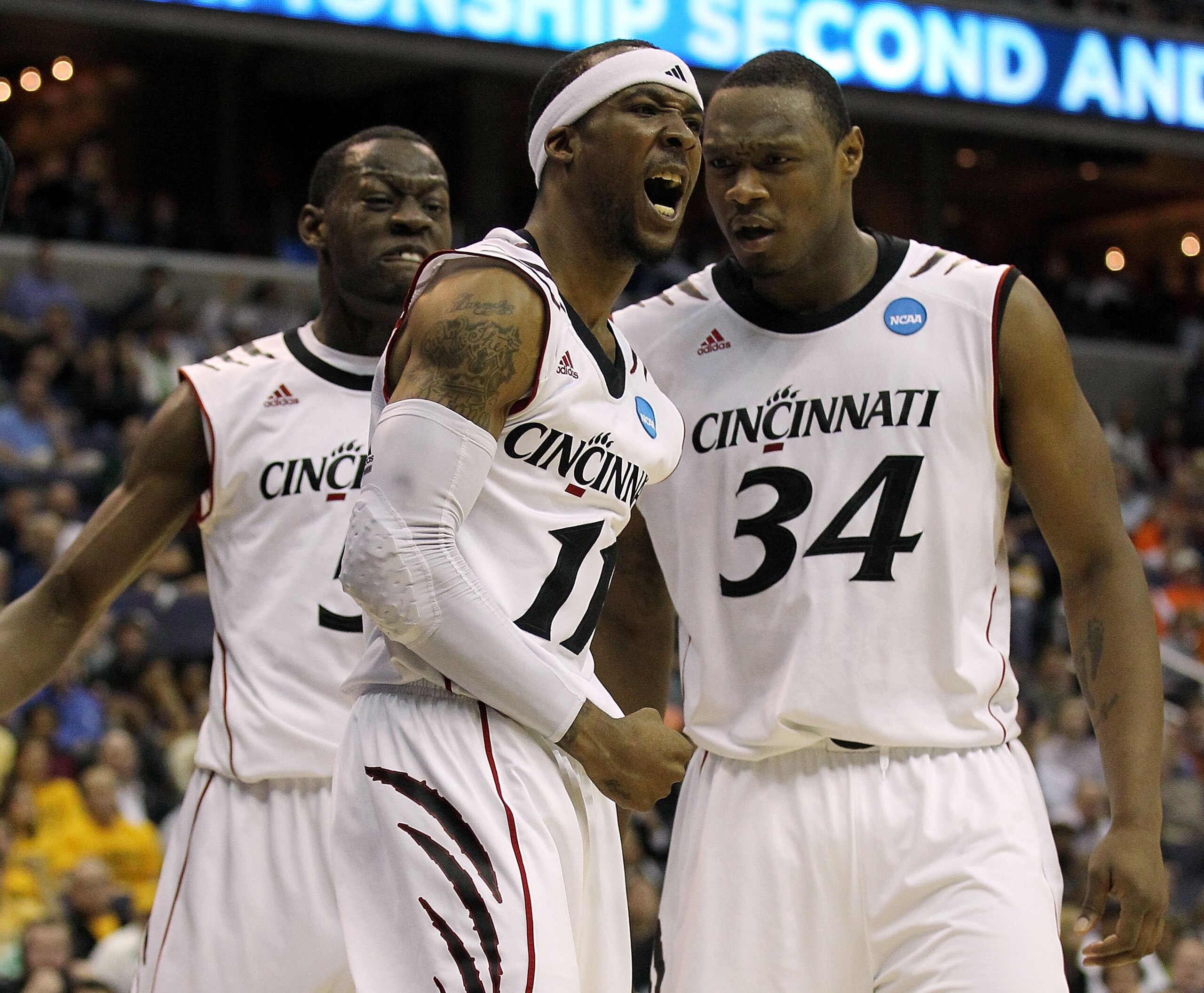 WASHINGTON - MARCH 17:  Larry Davis #11 of the Cincinnati Bearcats celebrates a dunk with teammates Yancy Gates #34 and Justin Jackson #5 against the Missouri Tigers during the second round of the 2011 NCAA men's basketball tournament at the Verizon Cente