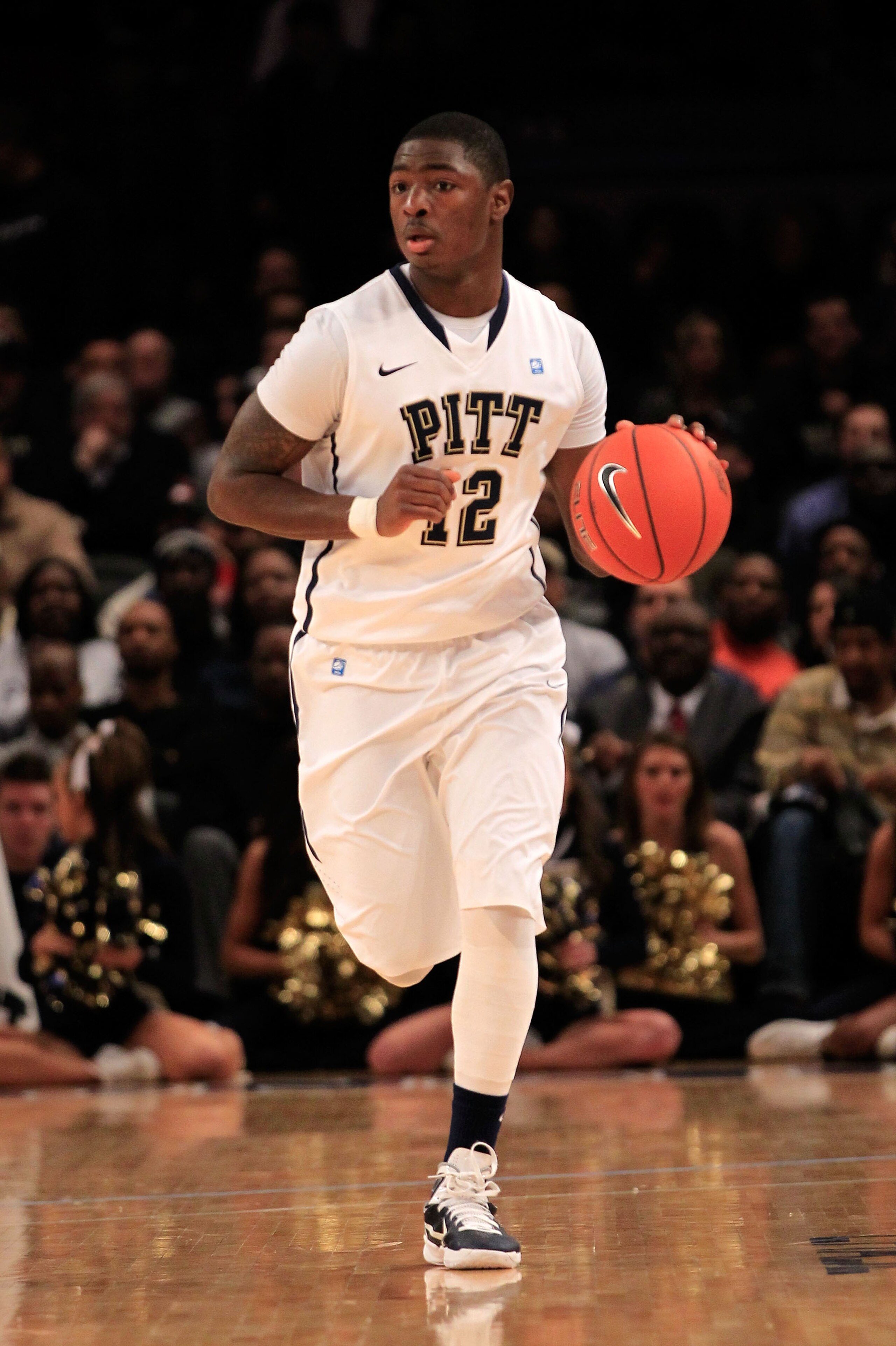 NEW YORK, NY - MARCH 10: Ashton Gibbs #12 of the Pittsburgh Panthers brings the ball up court against the Connecticut Huskies during the quarterfinals of the 2011 Big East Men's Basketball Tournament presented by American Eagle Outfitters  at Madison Squa