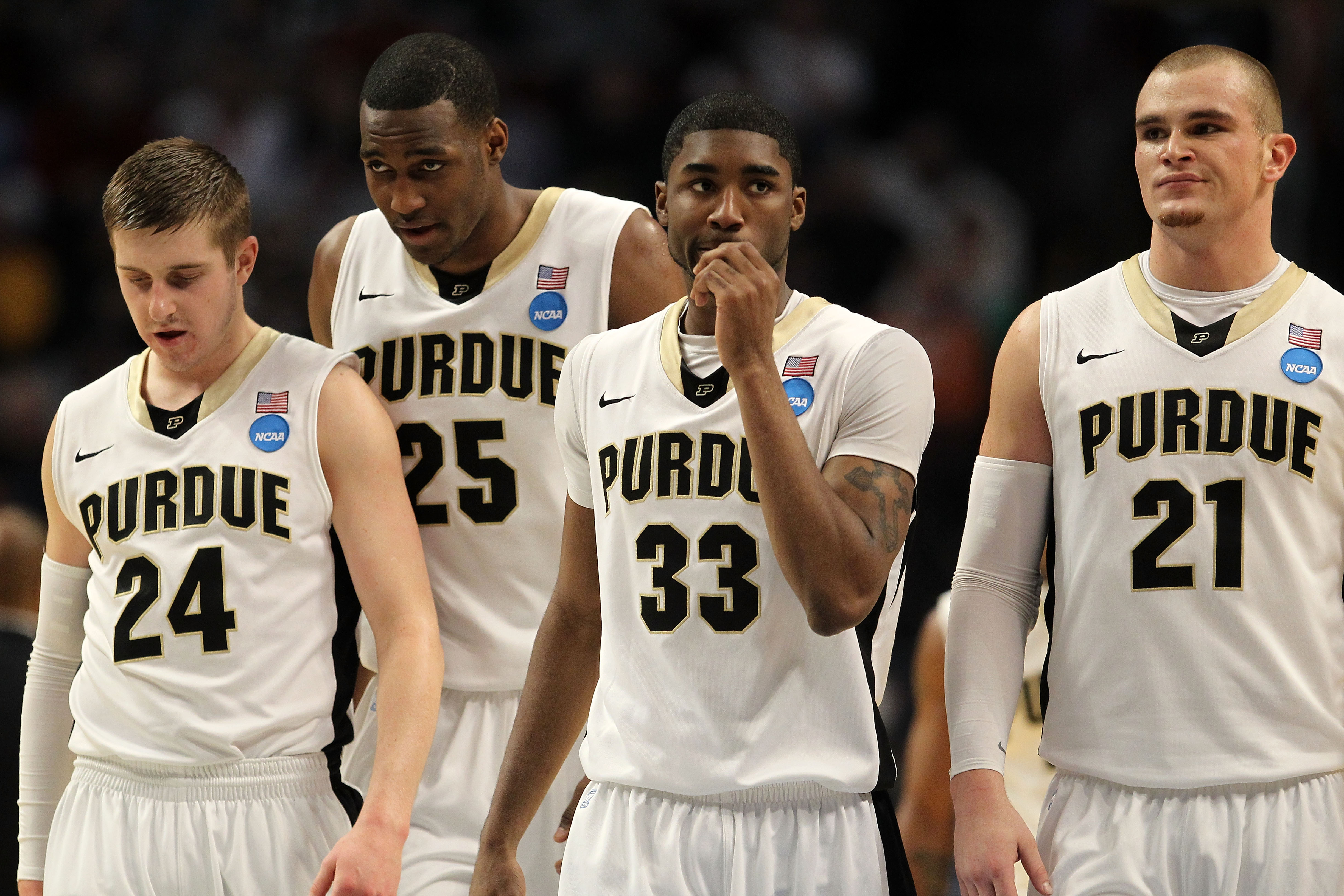 CHICAGO, IL - MARCH 18: Ryne Smith #24, JaJuan Johnson #25, E'Twaun Moore #33 and D.J. Byrd #21 of the Purdue Boilermakers look on while playing the St. Peter's Peacocks in the second half during the second round of the 2011 NCAA men's basketball tournam