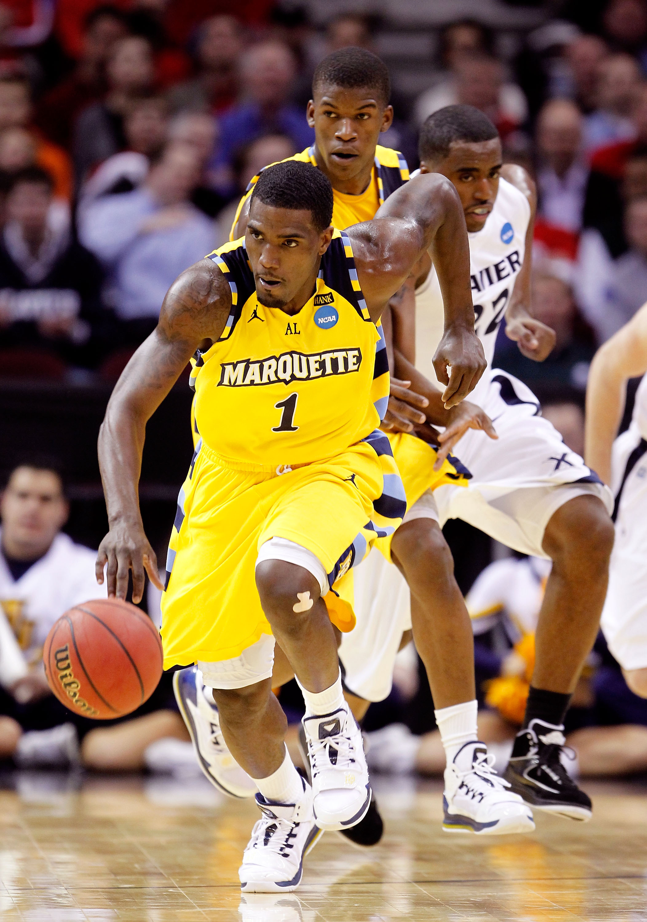 CLEVELAND, OH - MARCH 18: Darius Johnson-Odom #1 of the Marquette Golden Eagles brings the ball up court against the Xavier Musketeers during the second round of the 2011 NCAA men's basketball tournament at Quicken Loans Arena on March 18, 2011 in Clevela