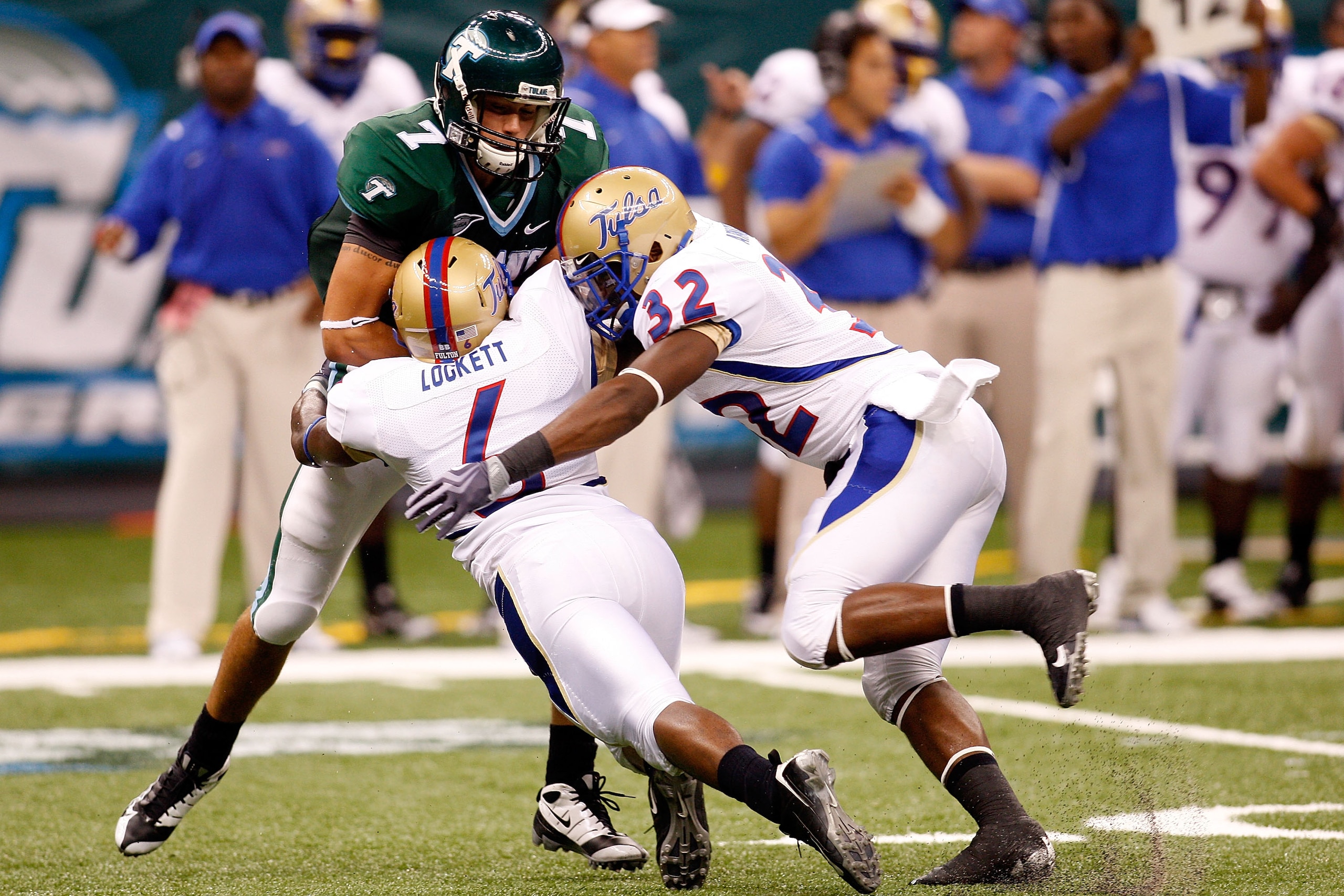 NEW ORLEANS - SEPTEMBER 04:  Quarterback Joe Kemp #7 of the Tulane Green Wave is sacked by Reid Singleton #4 and Curnelius Arnick #32 of the Tulsa Golden Hurricanes at the Louisiana Superdome on September 4, 2009 in New Orleans, Louisiana.  (Photo by Chri