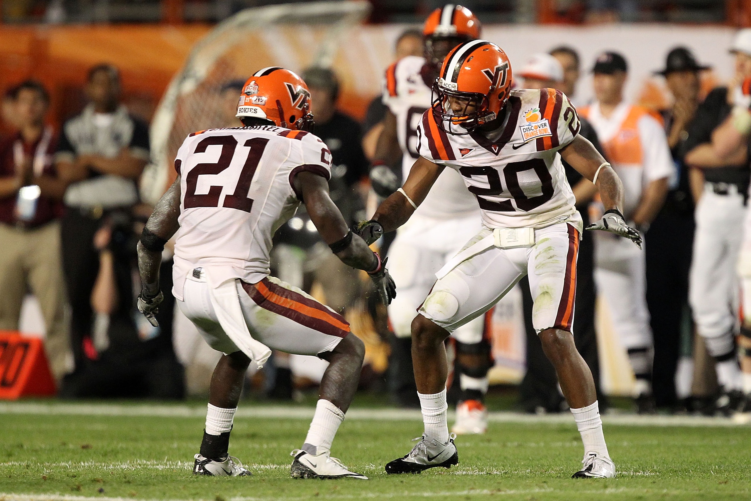 MIAMI, FL - JANUARY 03:  Rashad Carmichael #21 and Jayron Hosley #20 of the Virginai Tech Hokies celebrate after Hosley intercepted a pass in the second quarter against the Stanford Cardinal during the 2011 Discover Orange Bowl at Sun Life Stadium on Janu