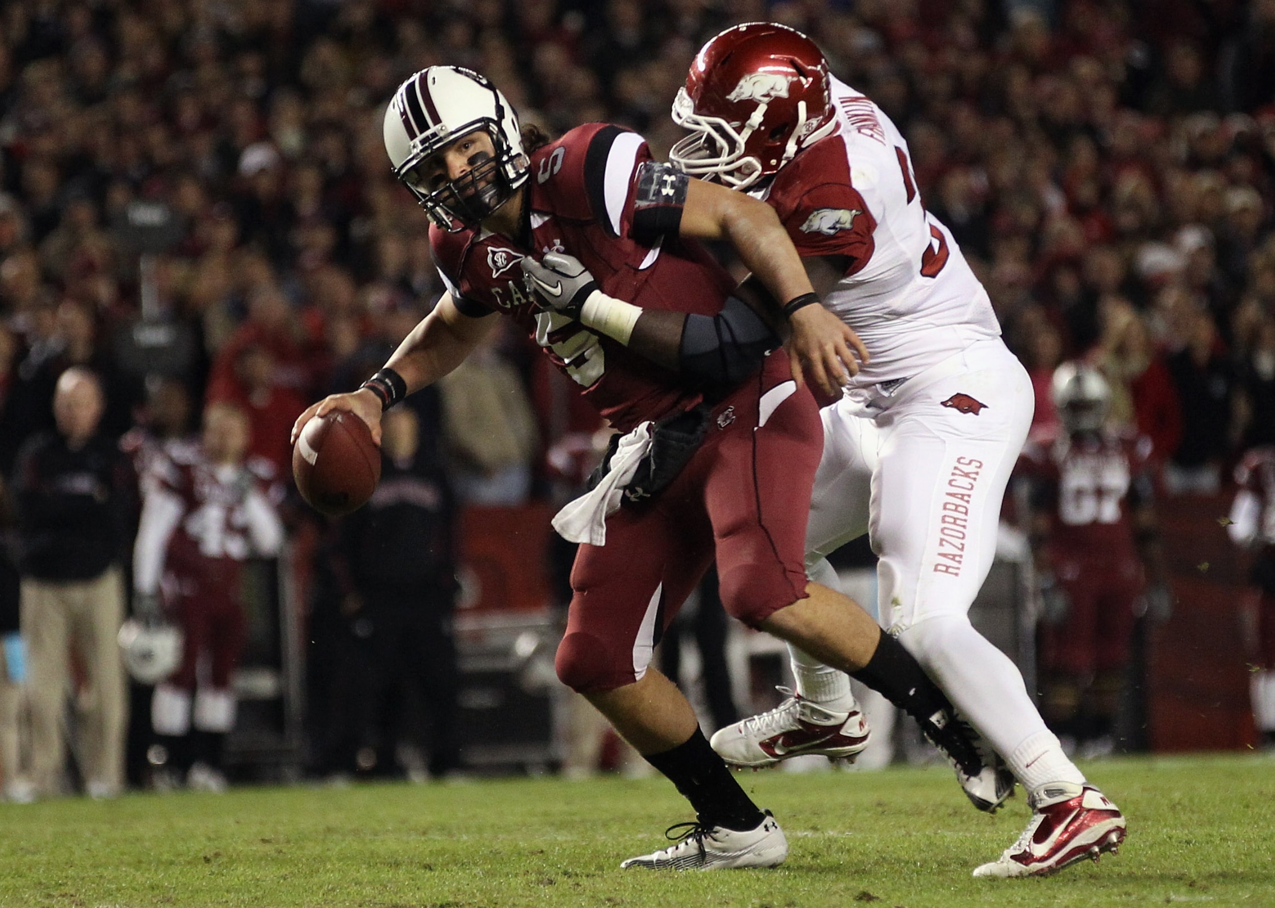 COLUMBIA, SC - NOVEMBER 06:  Jerry Franklin #34 of the Arkansas Razorbacks tries to bring down Stephen Garcia #5 of the South Carolina Gamecocks during their game at Williams-Brice Stadium on November 6, 2010 in Columbia, South Carolina.  (Photo by Street