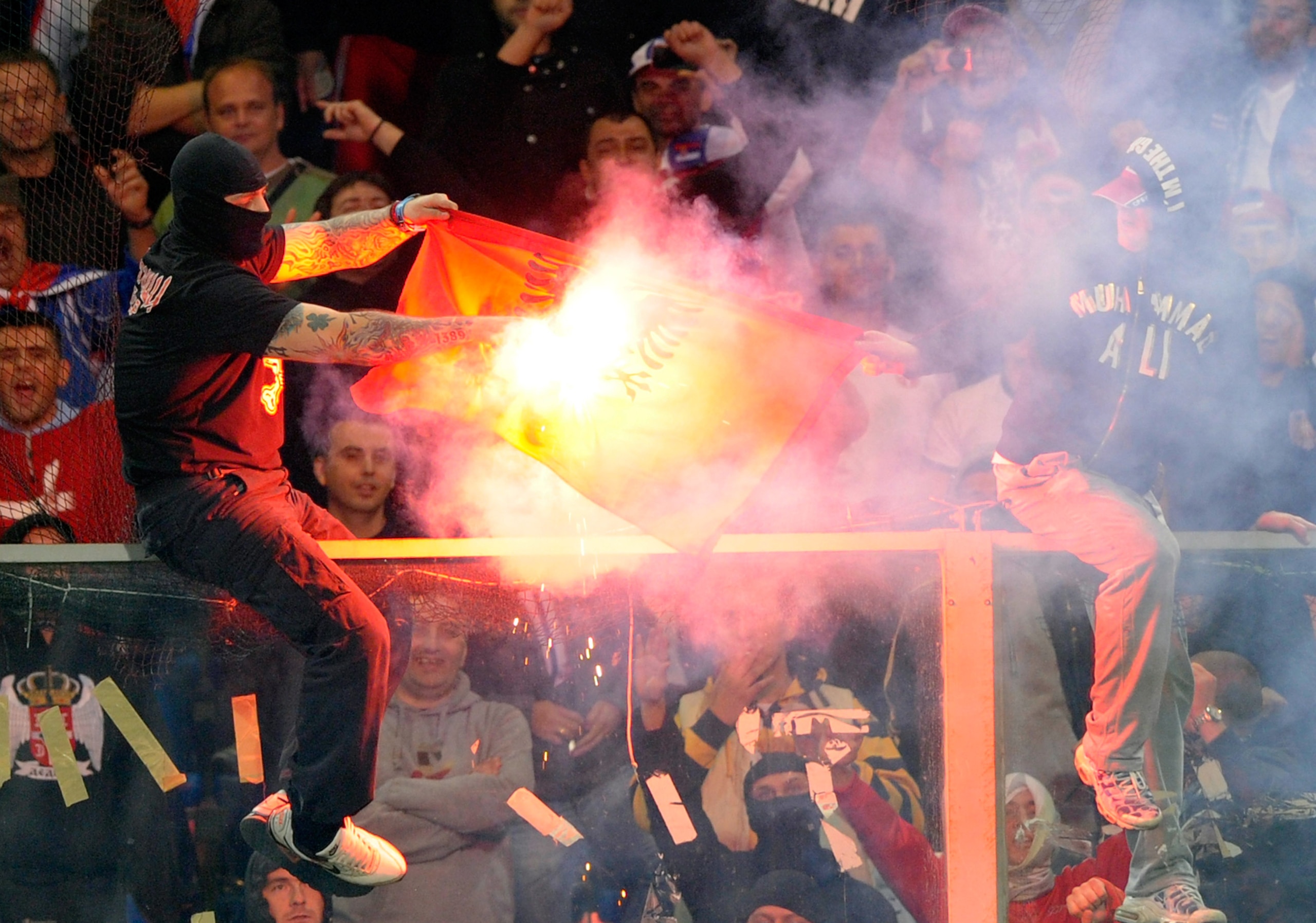 GENOA, ITALY - OCTOBER 12:  Balaclava clad Serbian fan Ivan Bogdanov gestures towards riot police during the UEFA Euro 2012 qualifying match between Italy and Serbia at Luigi Ferraris Stadium on October 12, 2010 in Genoa, Italy.  (Photo by Claudio Villa/G