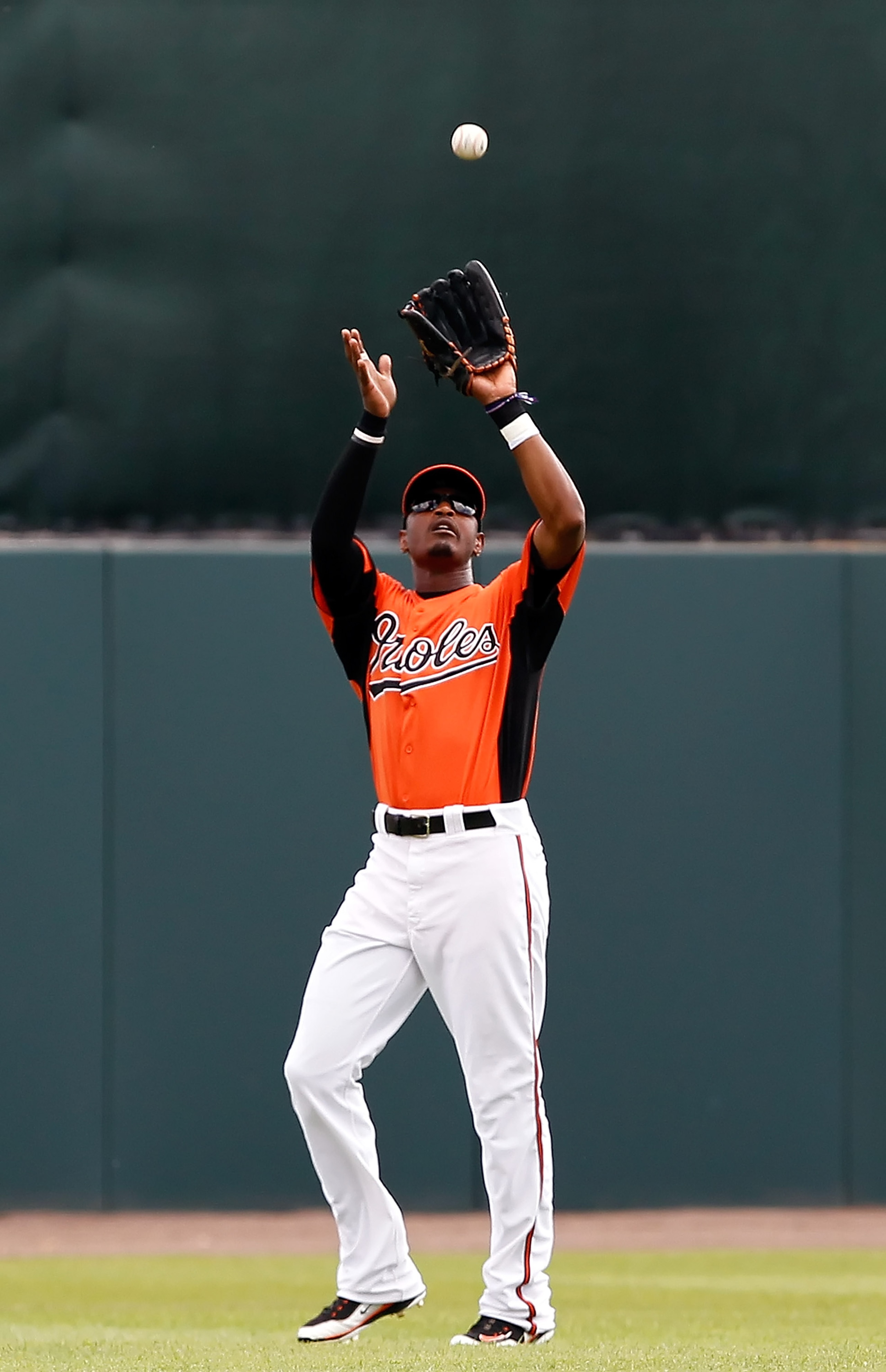 SARASOTA, FL - MARCH 05:  Outfielder Adam Jones #10 of the Baltimore Orioles catches a fly ball against the Boston Red Sox during a Grapefruit League Spring Training Game at Ed Smith Stadium on March 5, 2011 in Sarasota, Florida.  (Photo by J. Meric/Getty