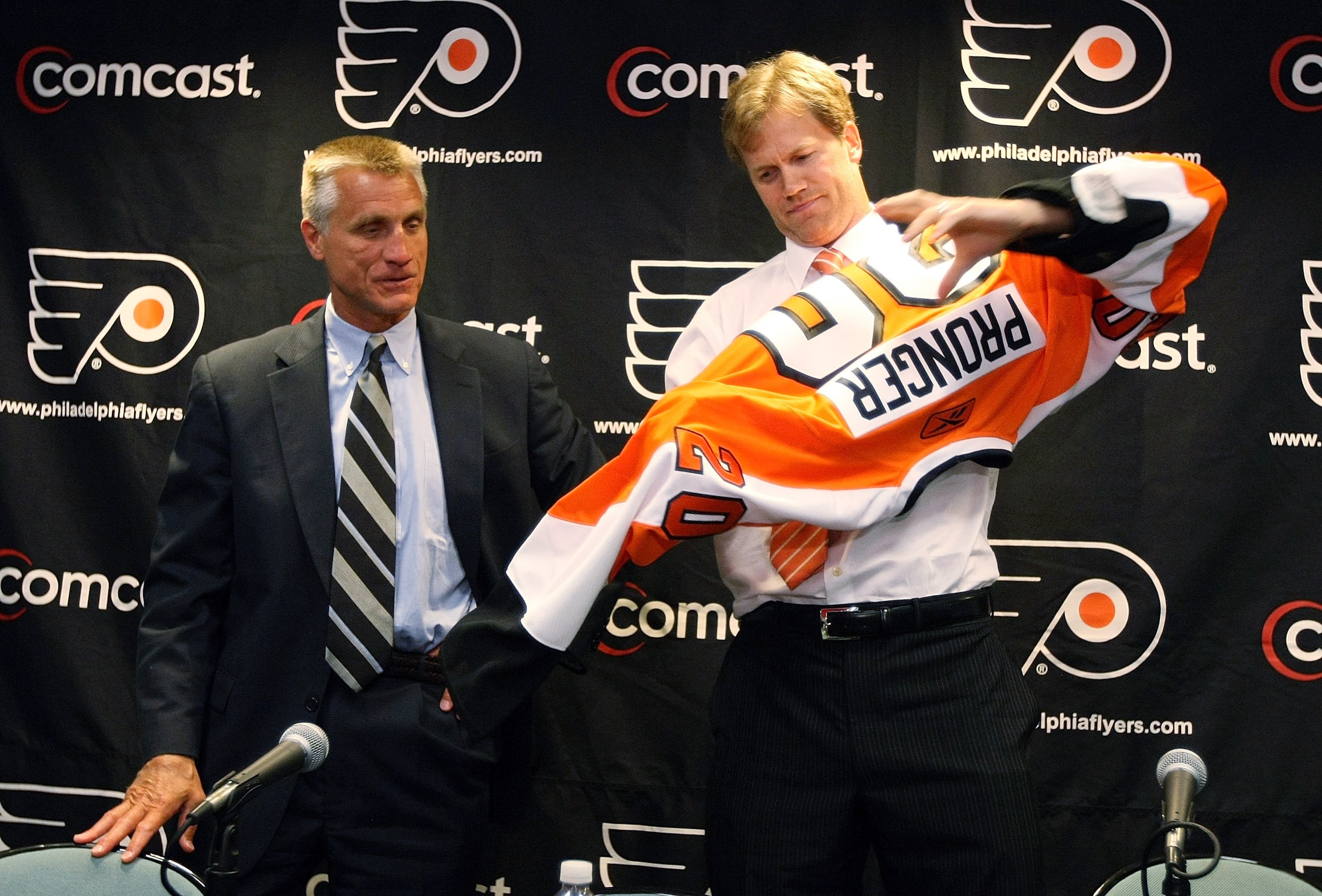 PHILADELPHIA - JULY 06: (L-R) Flyers General Manager, Paul Holmgren presents Chris Pronger #20 of the Philadelphia Flyers with his new jersey during his first press conference as a Philadelphia Flyer at Flyer's Skate Zone on July 6, 2009 in Philadelphia, PHILADELPHIA - JULY 06: (L-R) Flyers General Manager, Paul Holmgren presents Chris Pronger #20 of the Philadelphia Flyers with his new jersey during his first press conference as a Philadelphia Flyer at Flyer's Skate Zone on July 6, 2009 in Philadelphia,