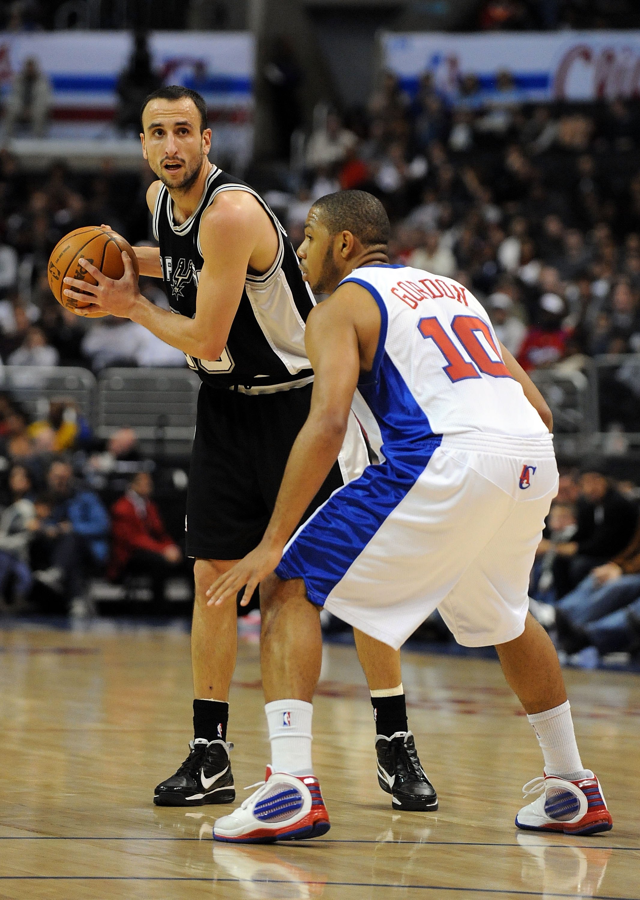 LOS ANGELES, CA - DECEMBER 13:  Manu Ginobli #20 of the San Antonio Spurs waits to pass in front of Eric Gordon #10 of the Los Angeles Clippers at Staples Center on December 13, 2009 in Los Angeles, California.  NOTE TO USER: User expressly acknowledges a