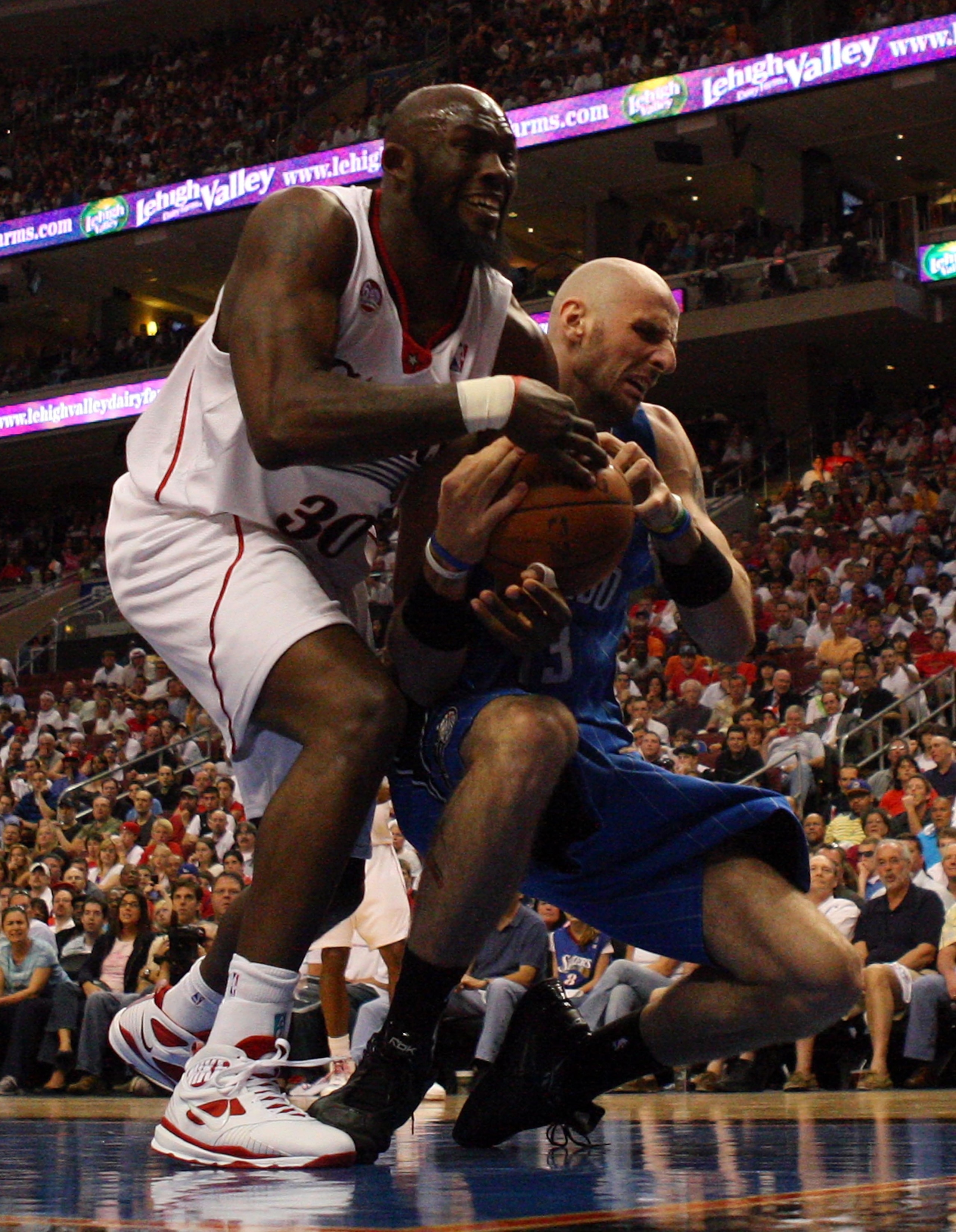 PHILADELPHIA - APRIL 26:  Reggie Evans #33 of the Philadelphia 76ers battles for the ball against Marcin Gortat #13 of the Orlando Magic during Game Four of the Eastern Conference Quarterfinals during the 2009 NBA Playoffs at the Wachovia Center on April