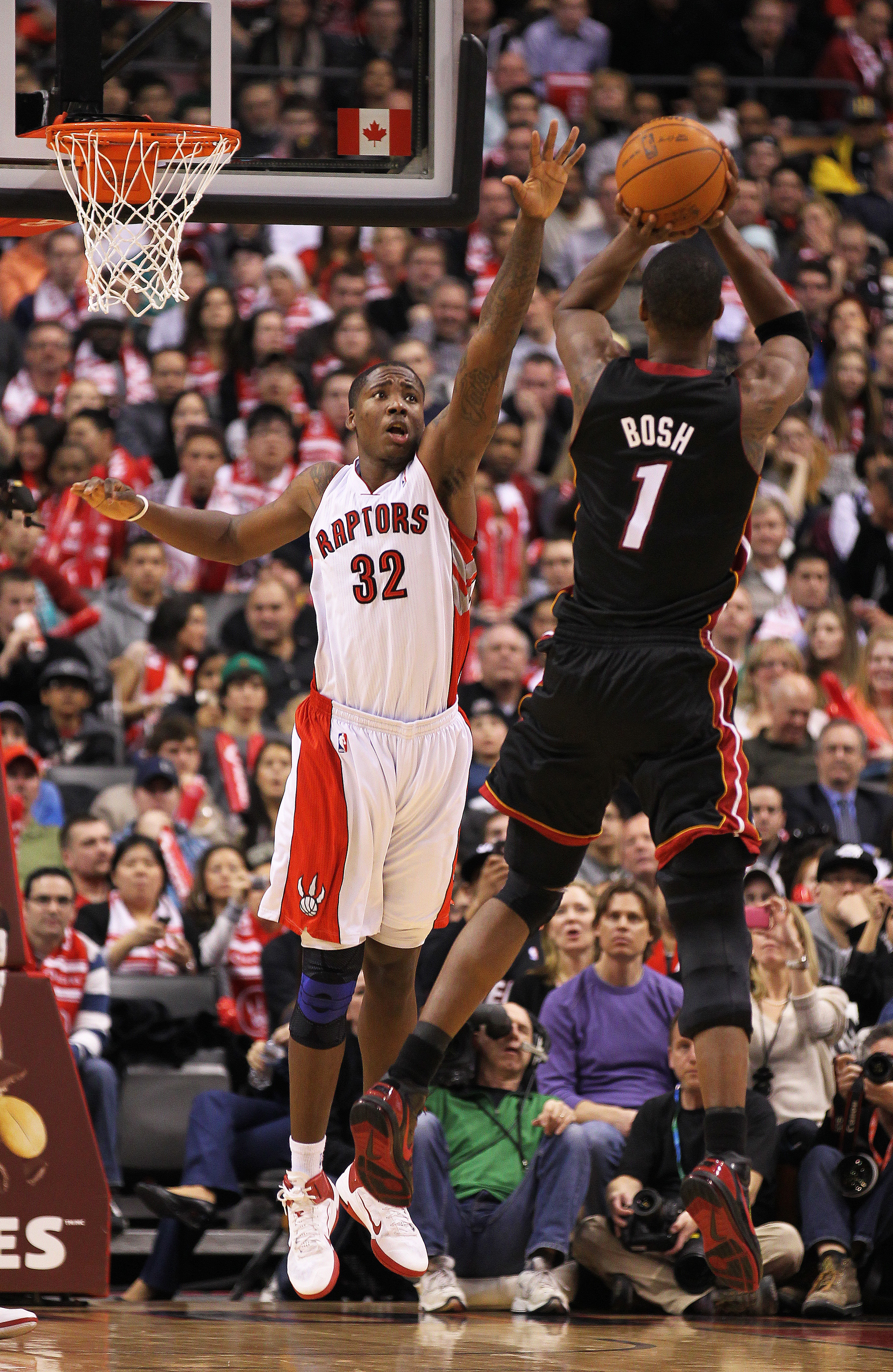 TORONTO, CAN - FEBRUARY 16:  Chris Bosh #1 of the Miami Heat shoots against  Ed Davis #32 of the Toronto Raptors in a game on February 16, 2011 at the Air Canada Centre in Toronto, Canada. The Heat defeated the Raptors 103-95. (Photo by Claus Andersen/Get