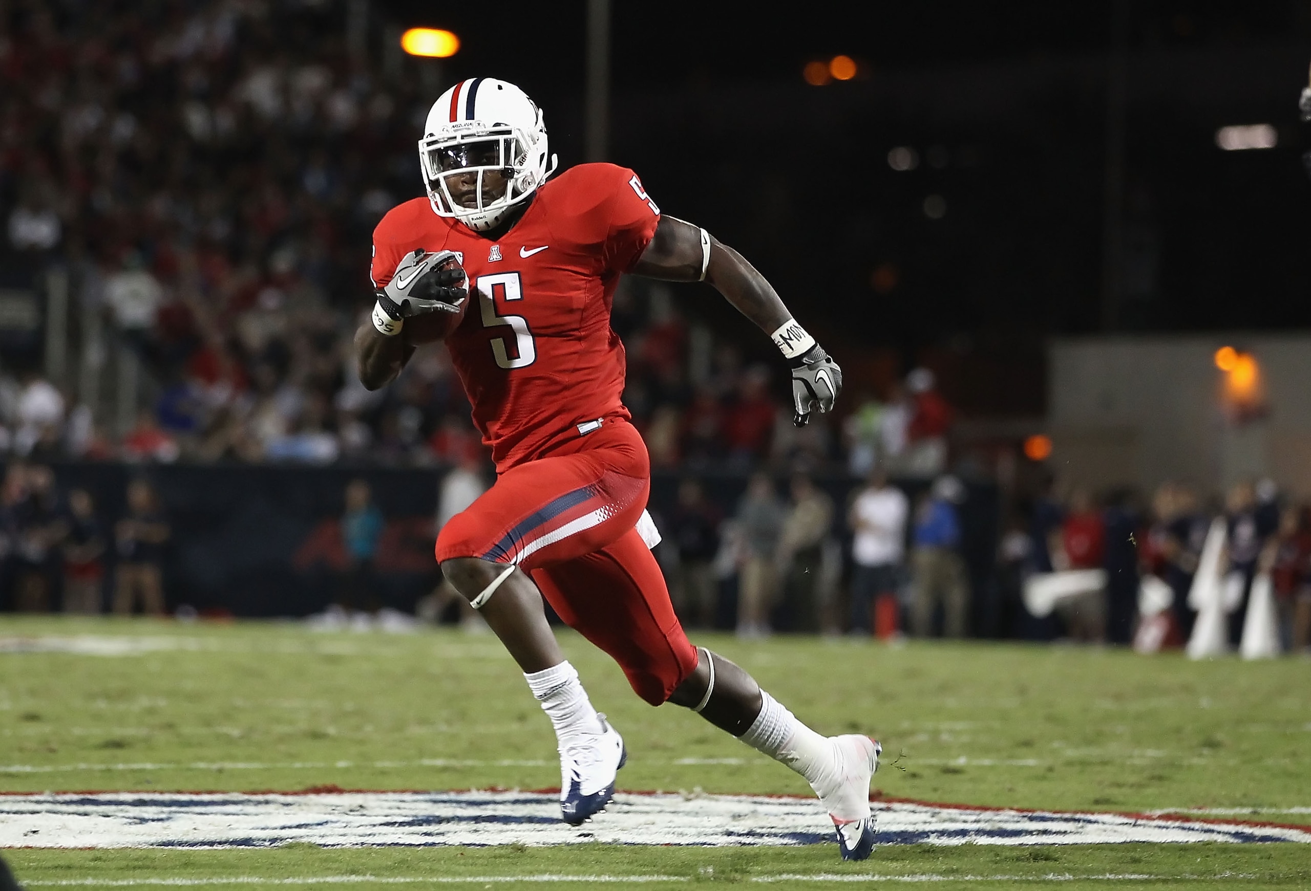 TUCSON, AZ - OCTOBER 23:  Runningback Nic Grigsby #5 of the Arizona Wildcats runs with the ball during the college football game against the Washington Huskies at Arizona Stadium on October 23, 2010 in Tucson, Arizona.   The Wildcats defeated the Huskies
