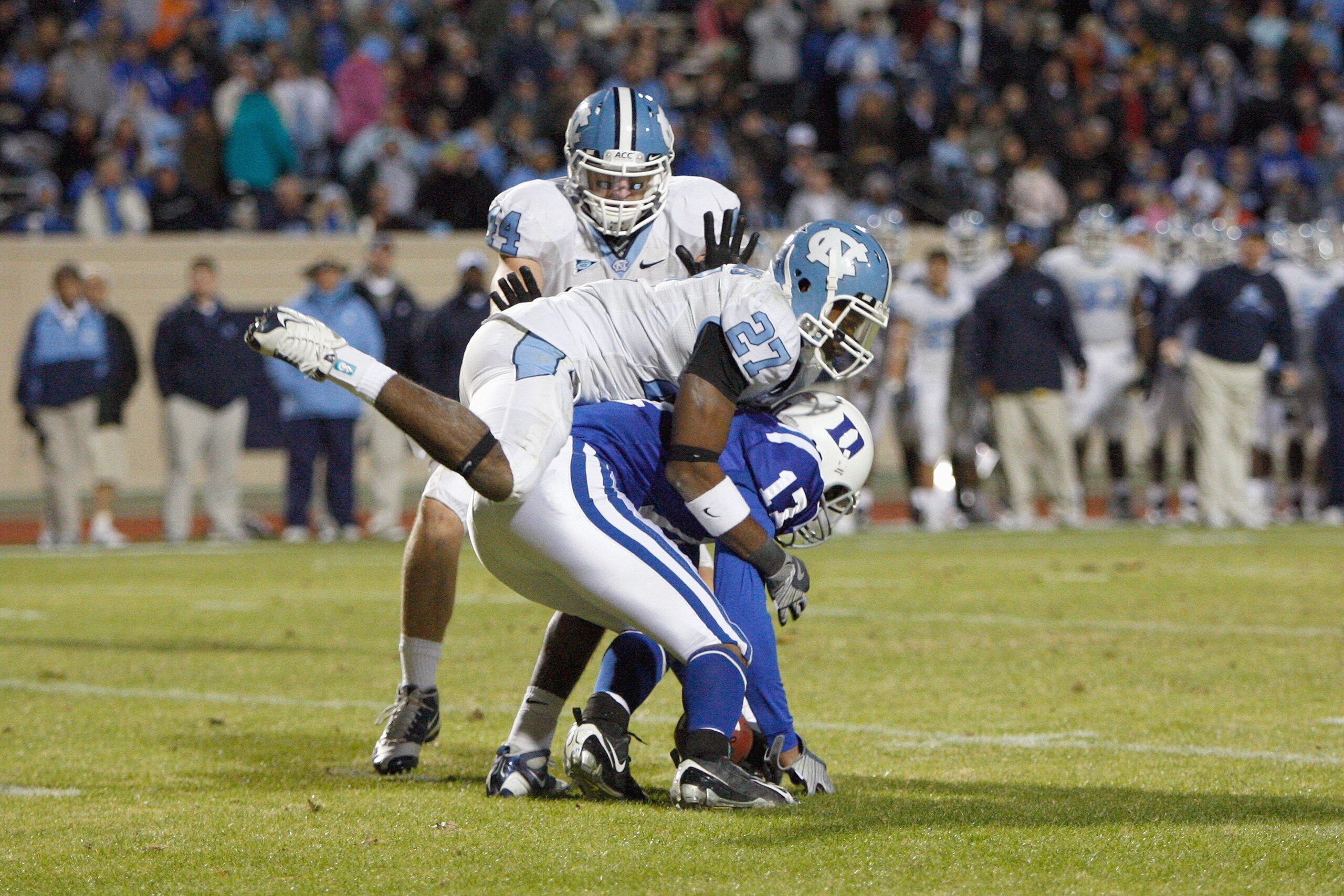 DURHAM, NC - NOVEMBER 29:  Sheldon Bell #17 of the Duke Blue Devils is tackled by Deunta Williams #27 and Chase Rice #44 of the North Carolina Tar Heels at Wallace Wade Stadium on November 29, 2008 in Durham, North Carolina. (Photo by Kevin C. Cox/Getty I