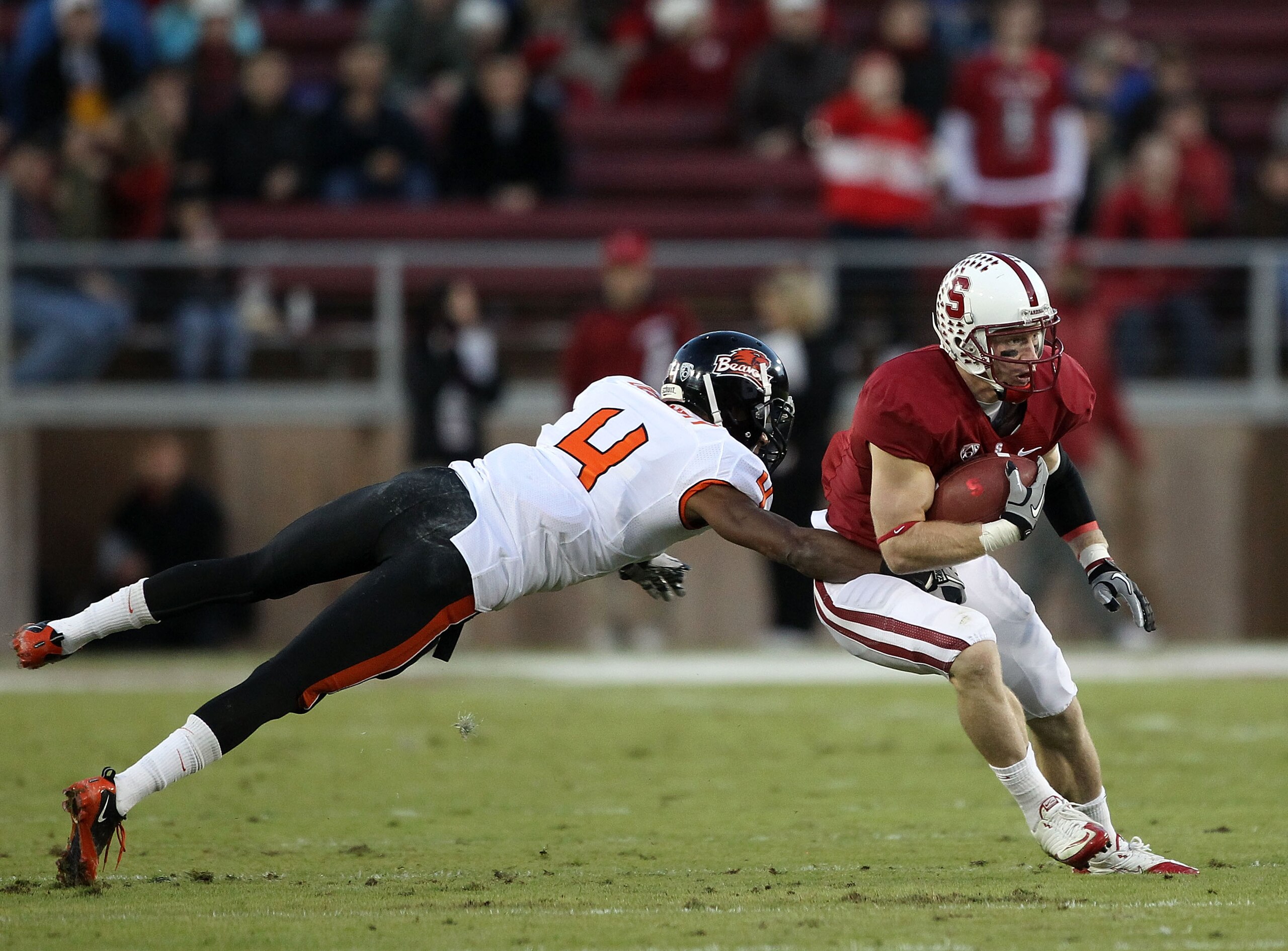PALO ALTO, CA - NOVEMBER 27:   Ryan Whalen #8 of the Stanford Cardinal avoid being tackled by a diving James Dockery #4 of the Oregon State Beavers at Stanford Stadium on November 27, 2010 in Palo Alto, California.  (Photo by Ezra Shaw/Getty Images)