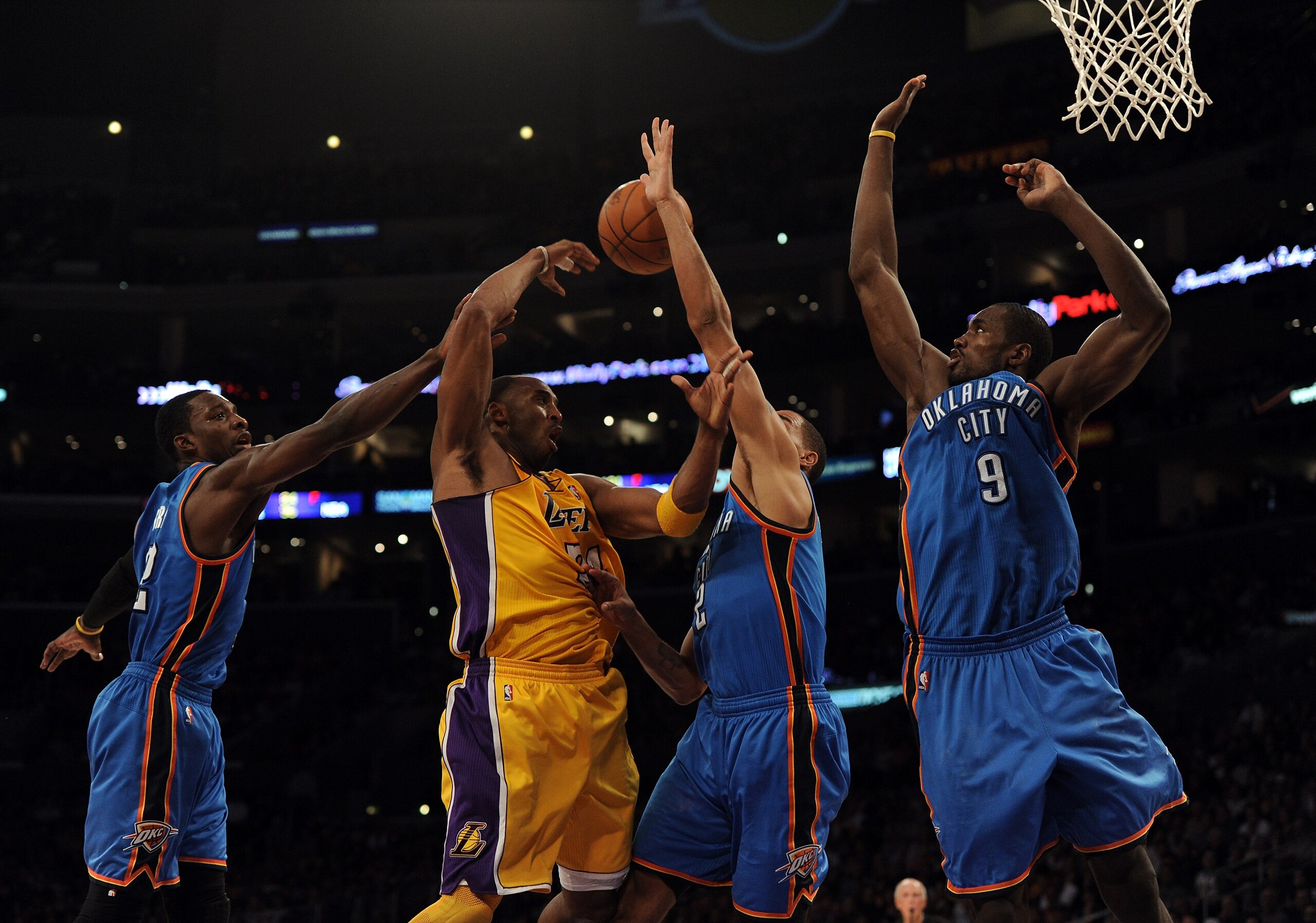 LOS ANGELES, CA - JANUARY 17:  Kobe Bryant #24 of the Los Angeles Lakers makes a pass around Serge Ibaka #9,Thabo Sefolosha #2 and Jeff Green #22 of the Oklahoma City Thunder at the Staples Center on January 17, 2011 in Los Angeles, California.  (Photo by