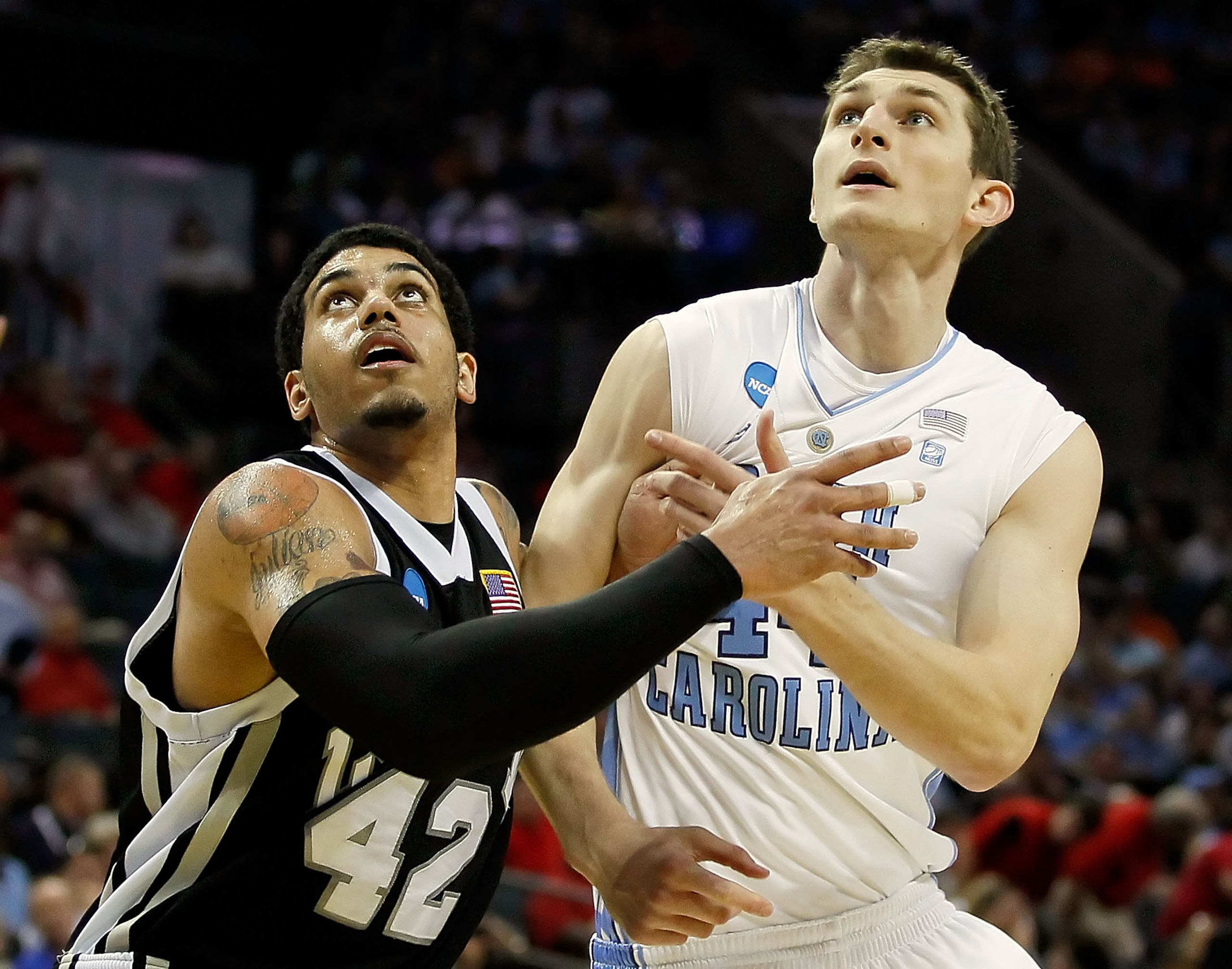 CHARLOTTE, NC - MARCH 18:  Julian Boyd #42 of the Long Island Blackbirds and Tyler Zeller #44 of the North Carolina Tar Heels battle for position for a rebound in the first half during the second round of the 2011 NCAA men's basketball tournament at Time