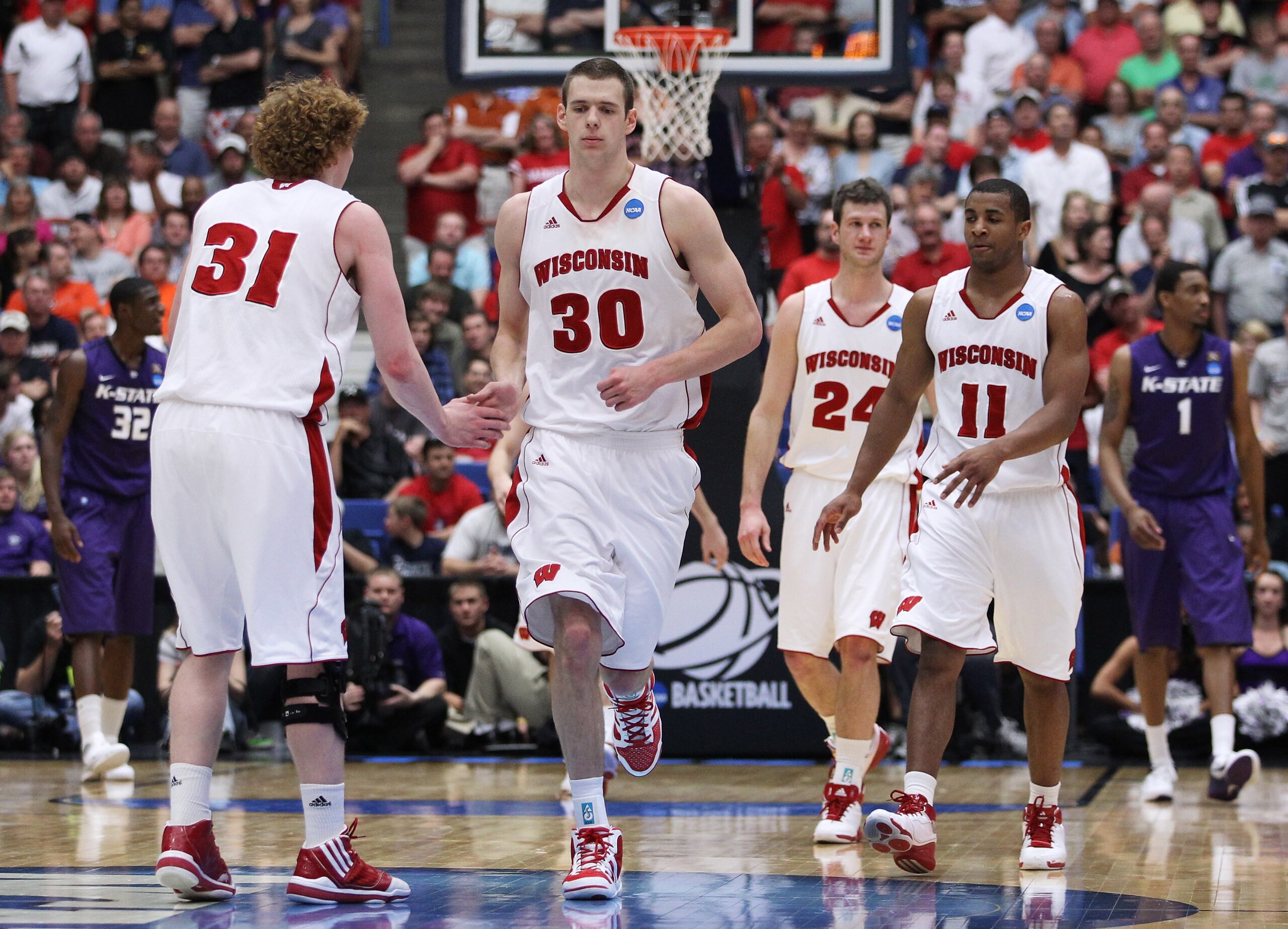 TUCSON, AZ - MARCH 19:  Mike Bruesewitz #31, Jon Leuer #30, Jordan Taylor #11 and Tim Jarmusz #24 of the Wisconsin Badgers celebrate during their 70 to 65 victory over the Kansas State Wildcats in the third round of the 2011 NCAA men's basketball tourname