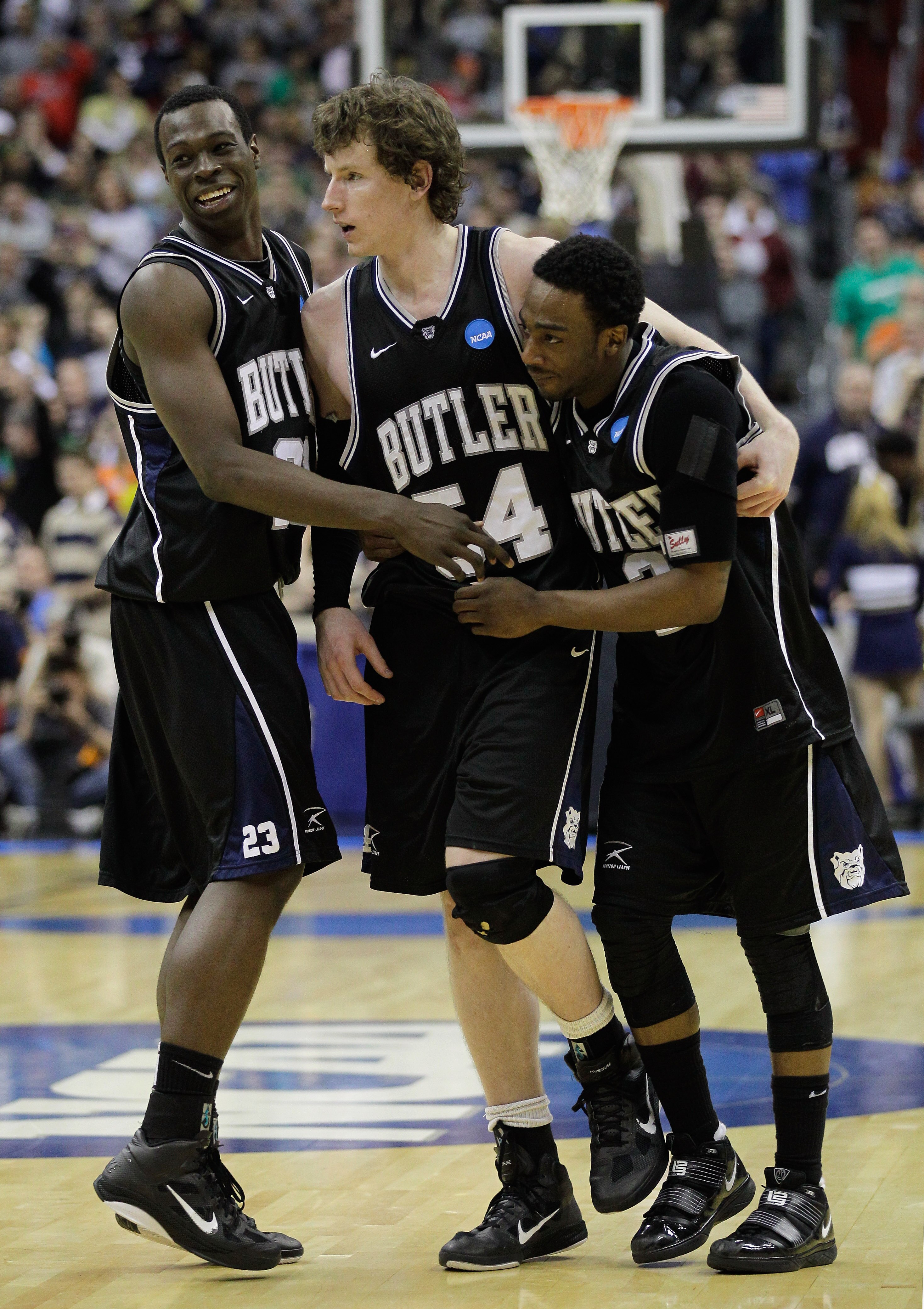 WASHINGTON - MARCH 19:  After making the game winning free throw, Matt Howard #54 of Butler is embraced by teammates Zach Hahn #3 and Khyle Marshall #23 in the third round of the 2011 NCAA men's basketball tournament at Verizon Center on March 19, 2011 in