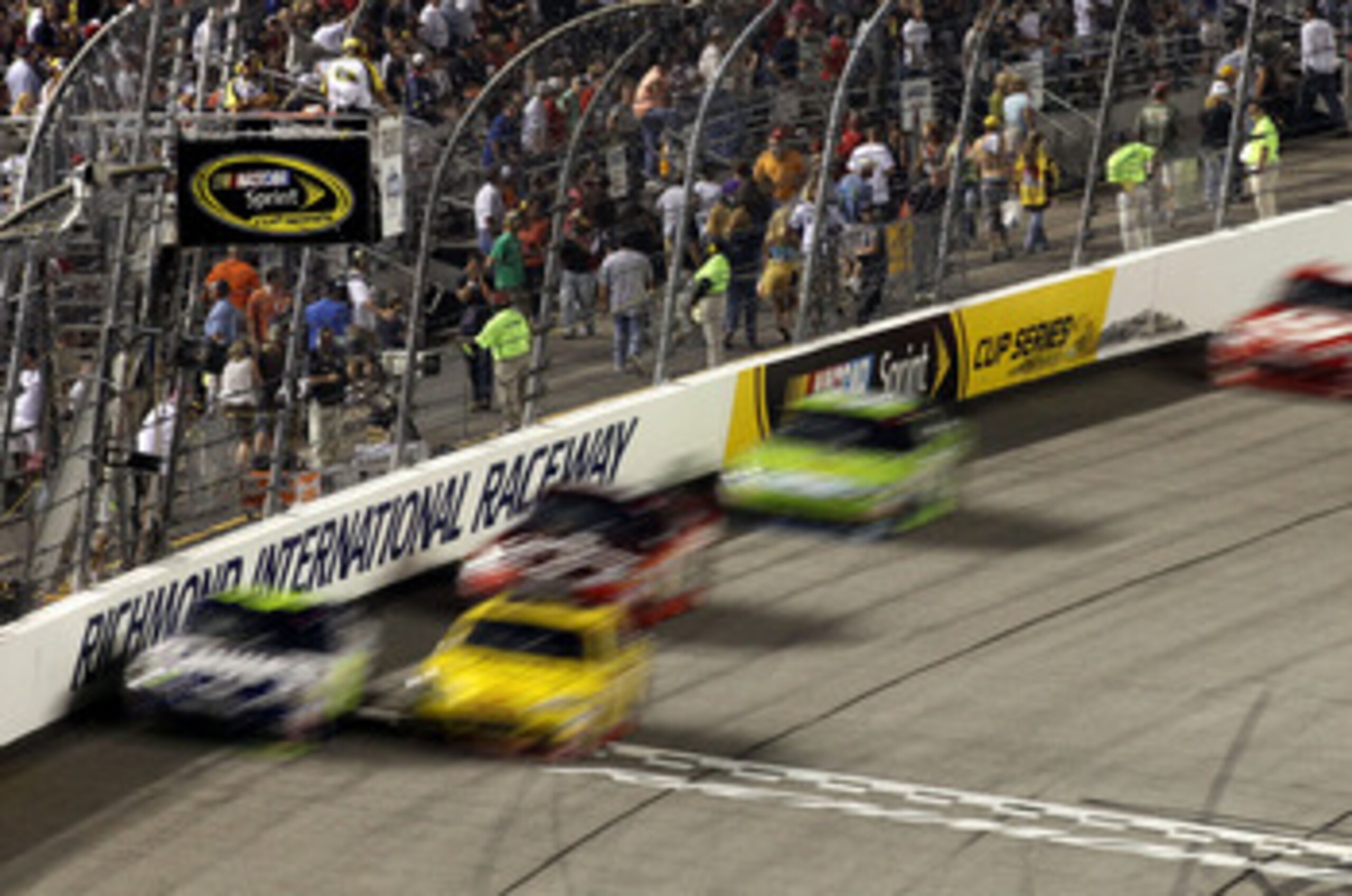 RICHMOND, VA - SEPTEMBER 11:  Denny Hamlin, driver of the #11 FedEx Office Toyota, and Clint Bowyer, driver of the #33Cheerios/Hamburger Helper Chevrolet, lead the field during the NASCAR Sprint Cup Series Air Guard 400 at Richmond International Raceway o