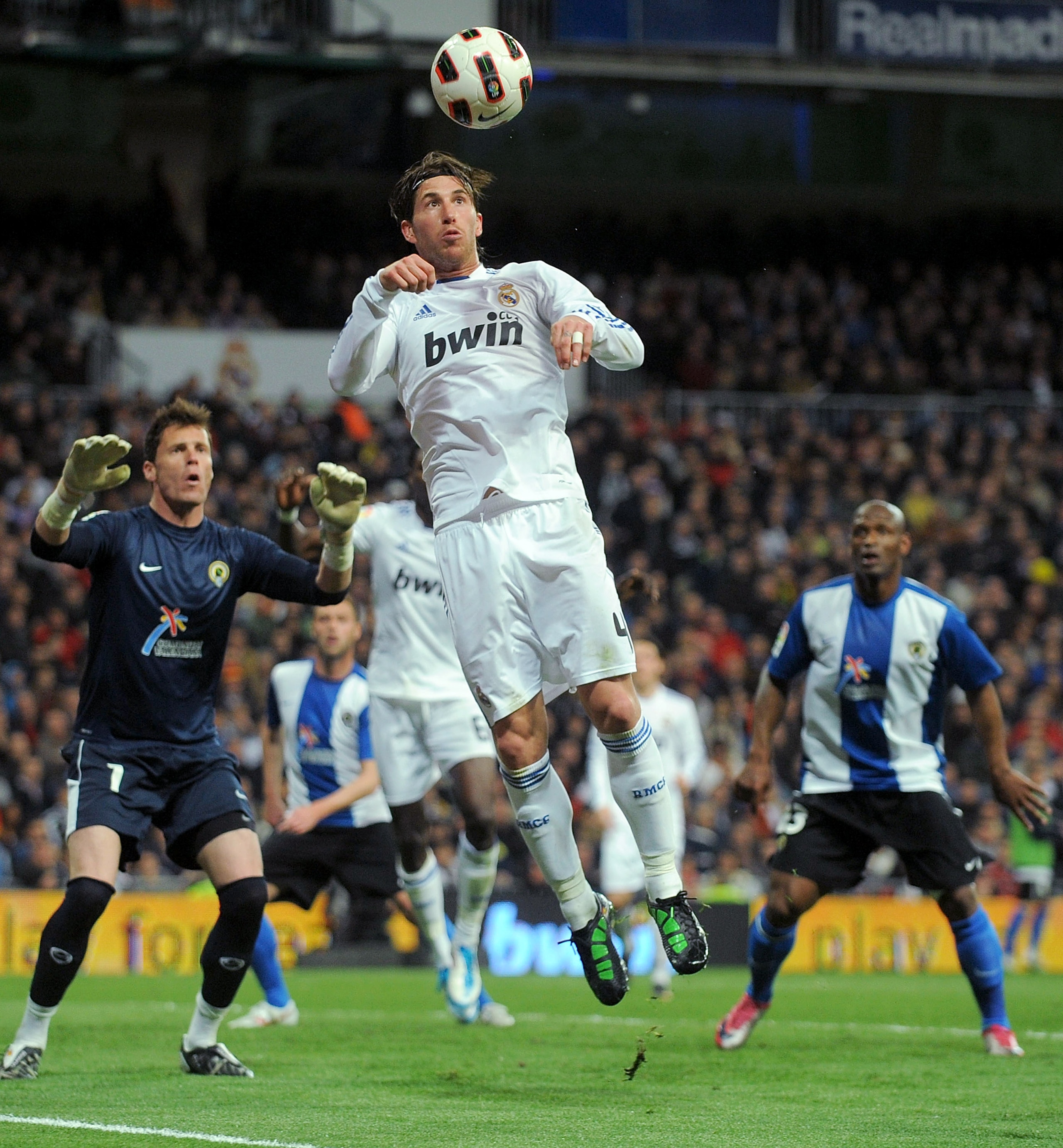 MADRID, SPAIN - MARCH 12:  Sergio Ramos of Real Madrid heads the ball from a corner kick during the La Liga match between Real Madrid and Hercules CF at Estadio Santiago Bernabeu on March 12, 2011 in Madrid, Spain.  (Photo by Denis Doyle/Getty Images)