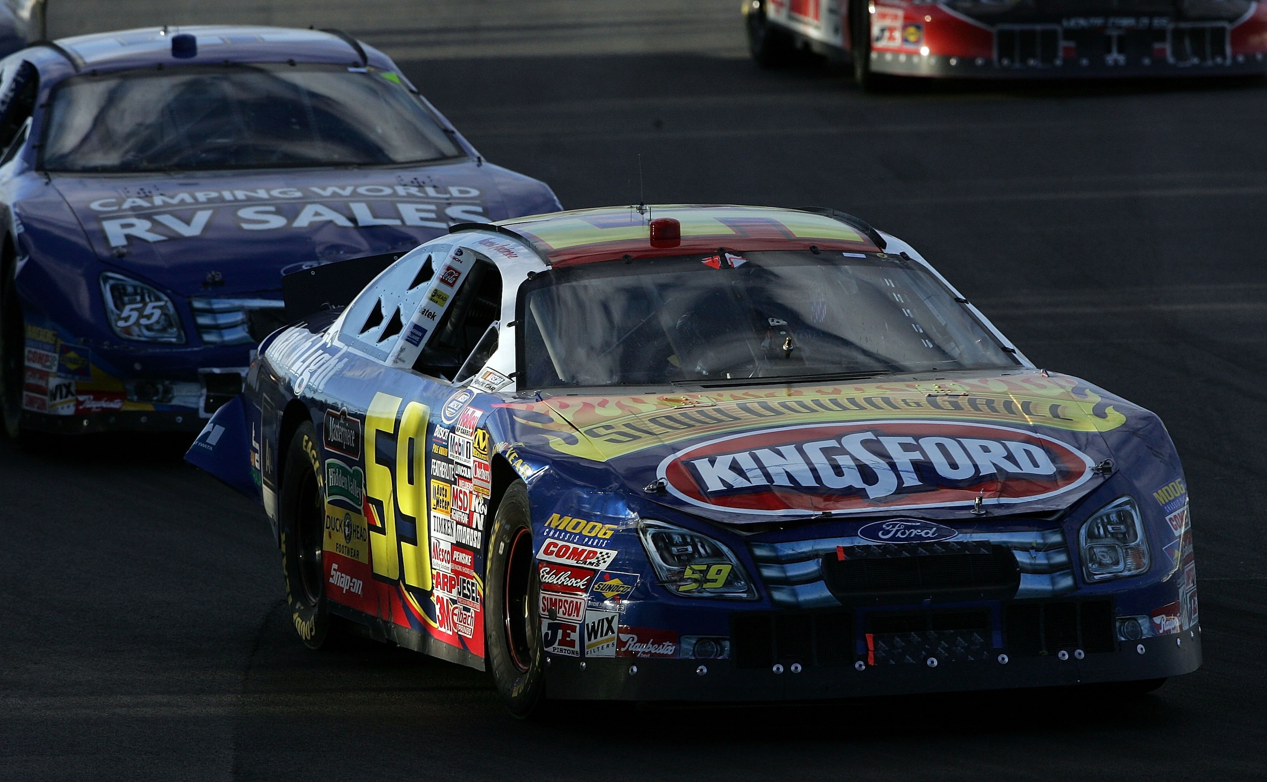 MONTREAL - AUGUST 4:  Marcos Ambrose, driver of the #59 Kingsford Ford, and Robby Gordon, driver of the #55 Camping World Ford, battle for position during the NASCAR Busch Series Napa Auto Parts 200 at the Circuit Gilles Villeneuve August 4, 2007 in Montr
