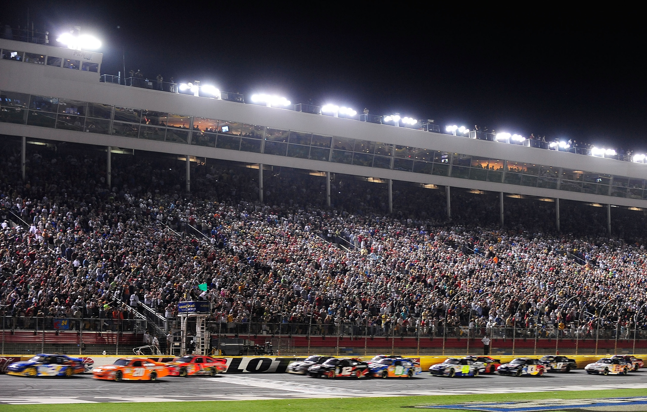 CONCORD, NC - MAY 22:  Kurt Busch, driver of the #2 Miller Lite Dodge, and Joey Logano, driver of the #20 The Home Depot Toyota, lead the field to the green flag to start the NASCAR Sprint All-Star Race at Charlotte Motor Speedway on May 22, 2010 in Conco