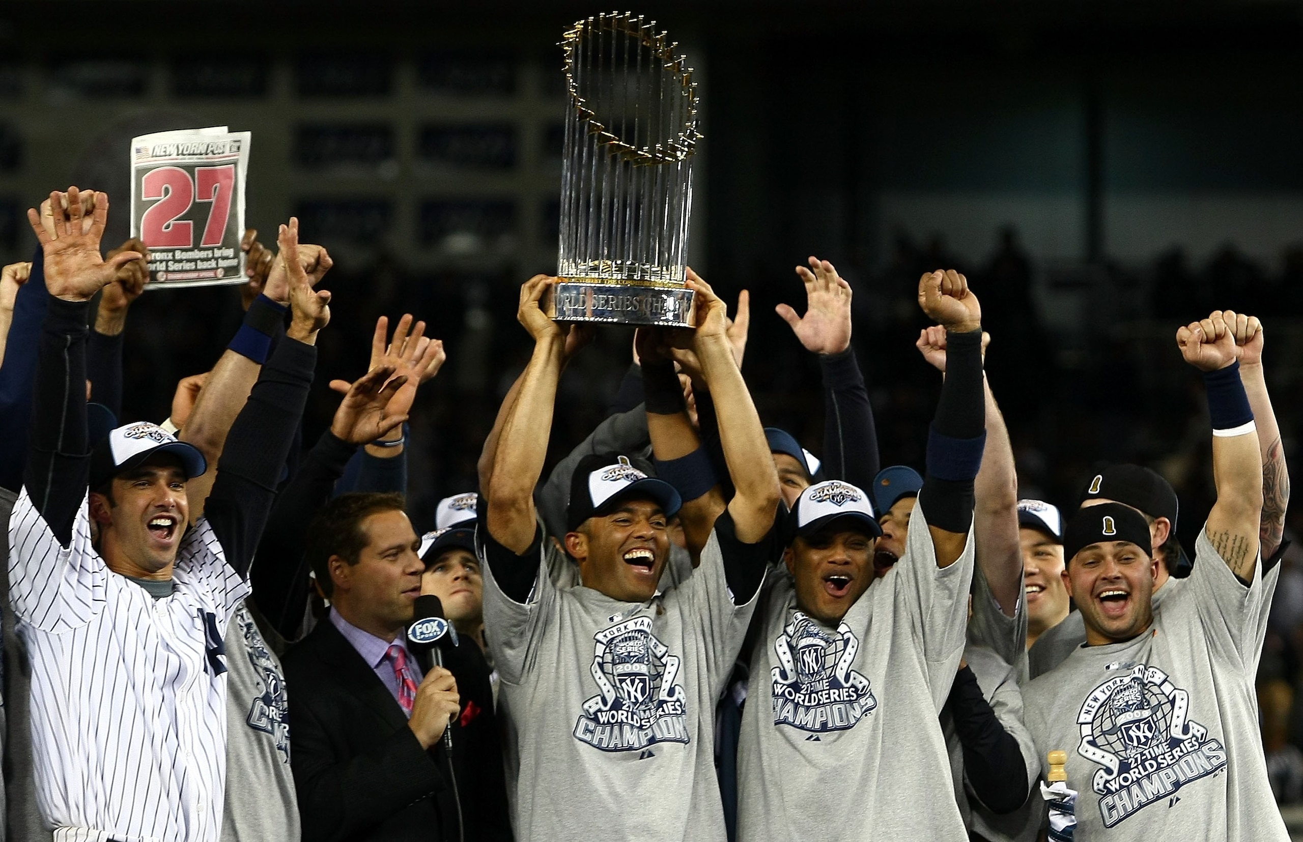 NEW YORK - NOVEMBER 04:  Jorge Posada #20, Mariano Mrivera #42, Robinson Cano #24 and Nick Swisher #33 of the New York Yankees celebrate with the trophy after their 7-3 win against the Philadelphia Phillies in Game Six of the 2009 MLB World Series at Yank