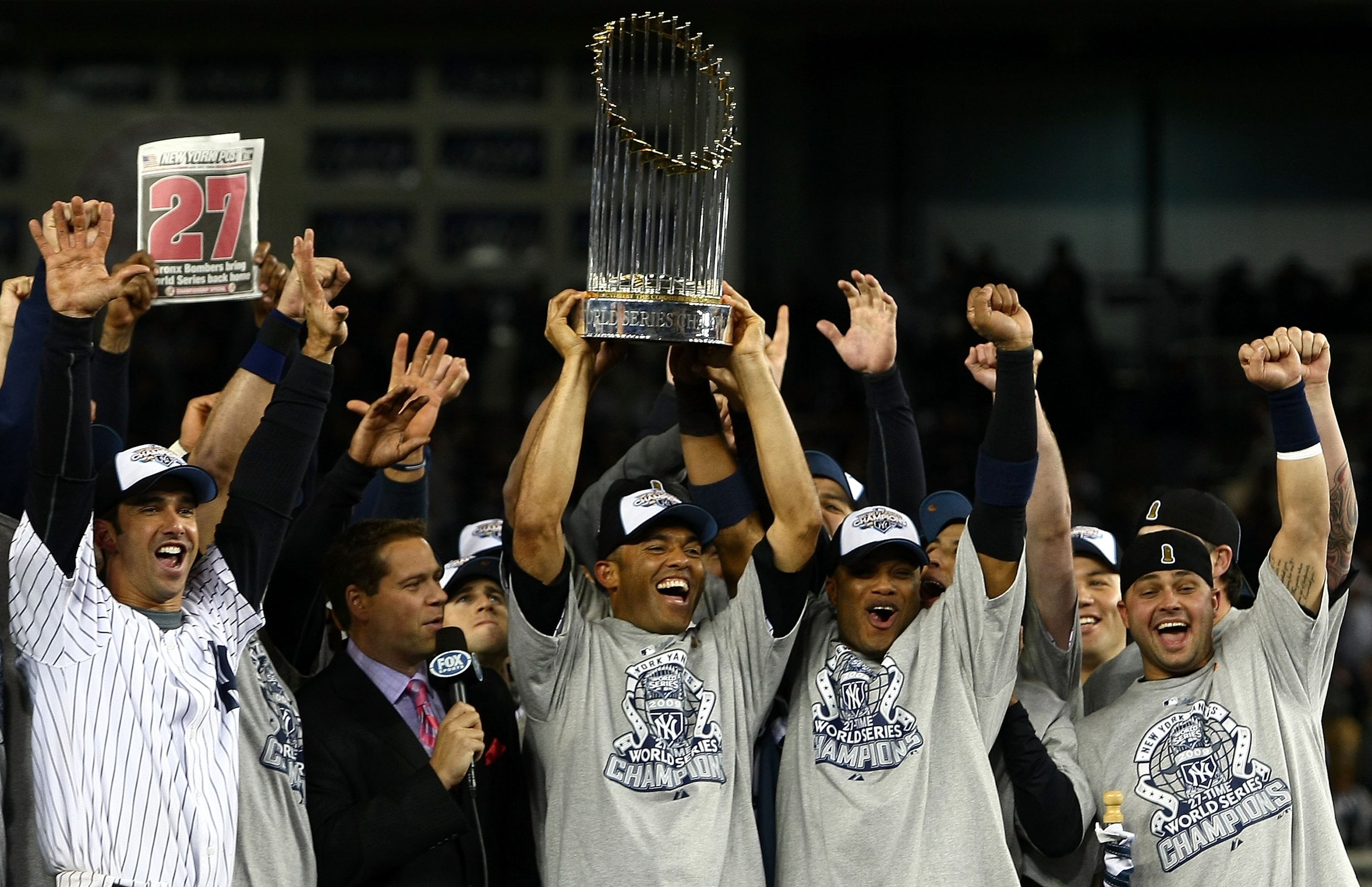 NEW YORK - NOVEMBER 04:  Jorge Posada #20, Mariano Mrivera #42, Robinson Cano #24 and Nick Swisher #33 of the New York Yankees celebrate with the trophy after their 7-3 win against the Philadelphia Phillies in Game Six of the 2009 MLB World Series at Yank