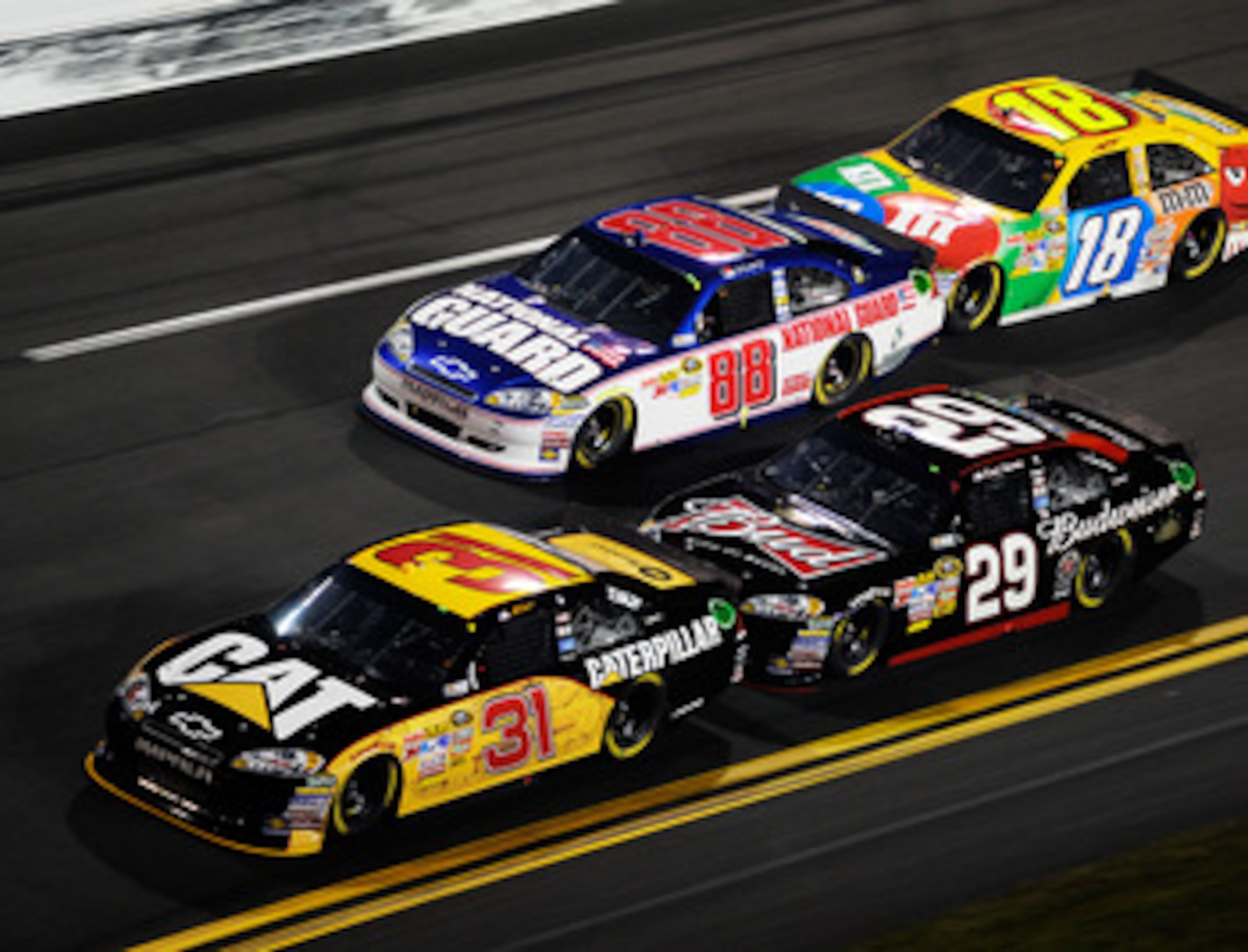 DAYTONA BEACH, FL - FEBRUARY 12:  Jeff Burton, driver of the #31 Caterpilliar Chevrolet, leads Kevin Harvick, driver of the #29 Budweiser Chevrolet, Dale Earnhardt Jr., driver of the #88 National Guard/AMP Energy Chevrolet, and Kyle Busch, driver of the #