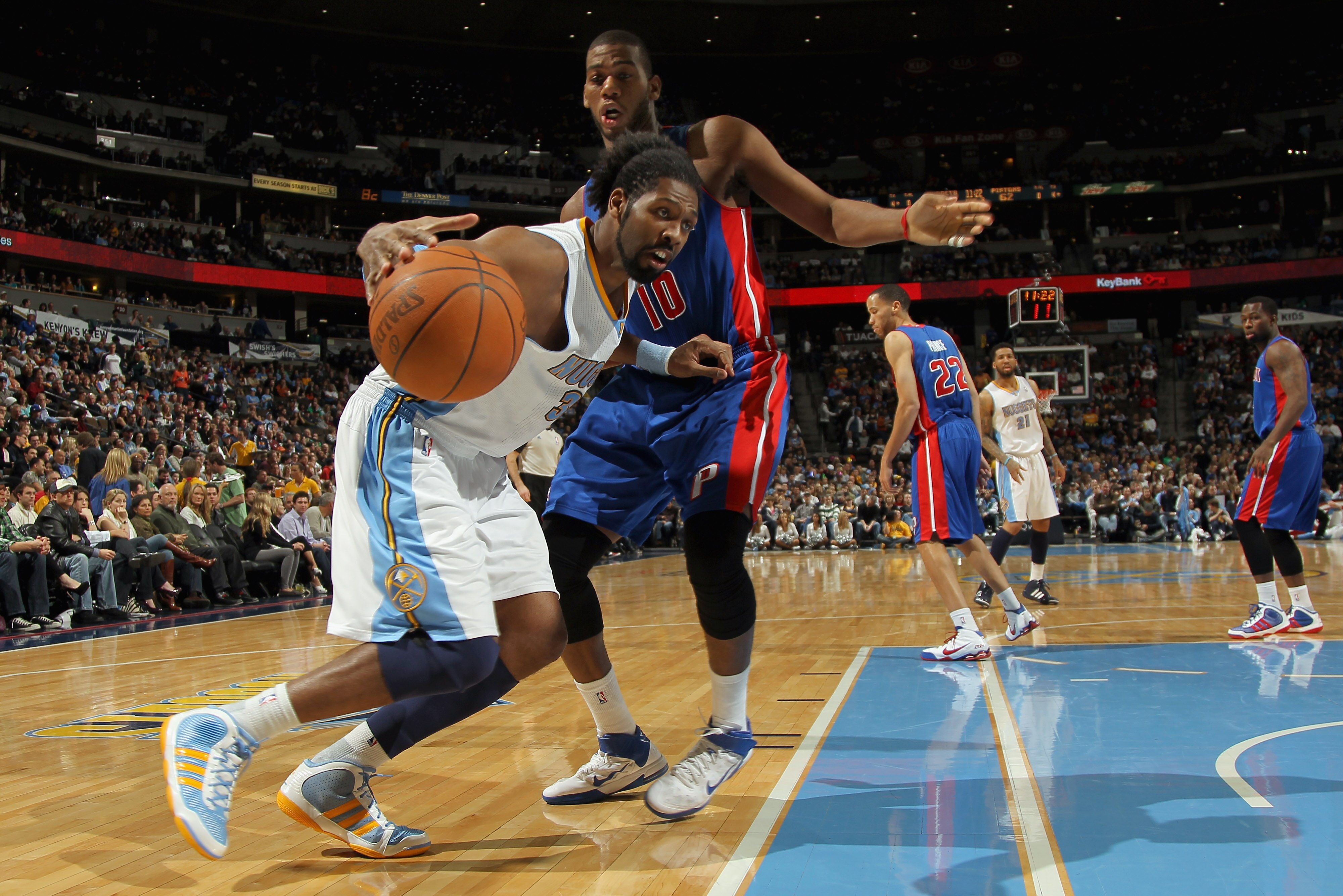 DENVER, CO - MARCH 12:  Nene #31 of the Denver Nuggets drives to the basket against the defense of Greg Monroe #10 of the Detroit Pistons at the Pepsi Center on March 12, 2011 in Denver, Colorado. The Nuggets defeated the Pistons 131-101.  NOTE TO USER: U