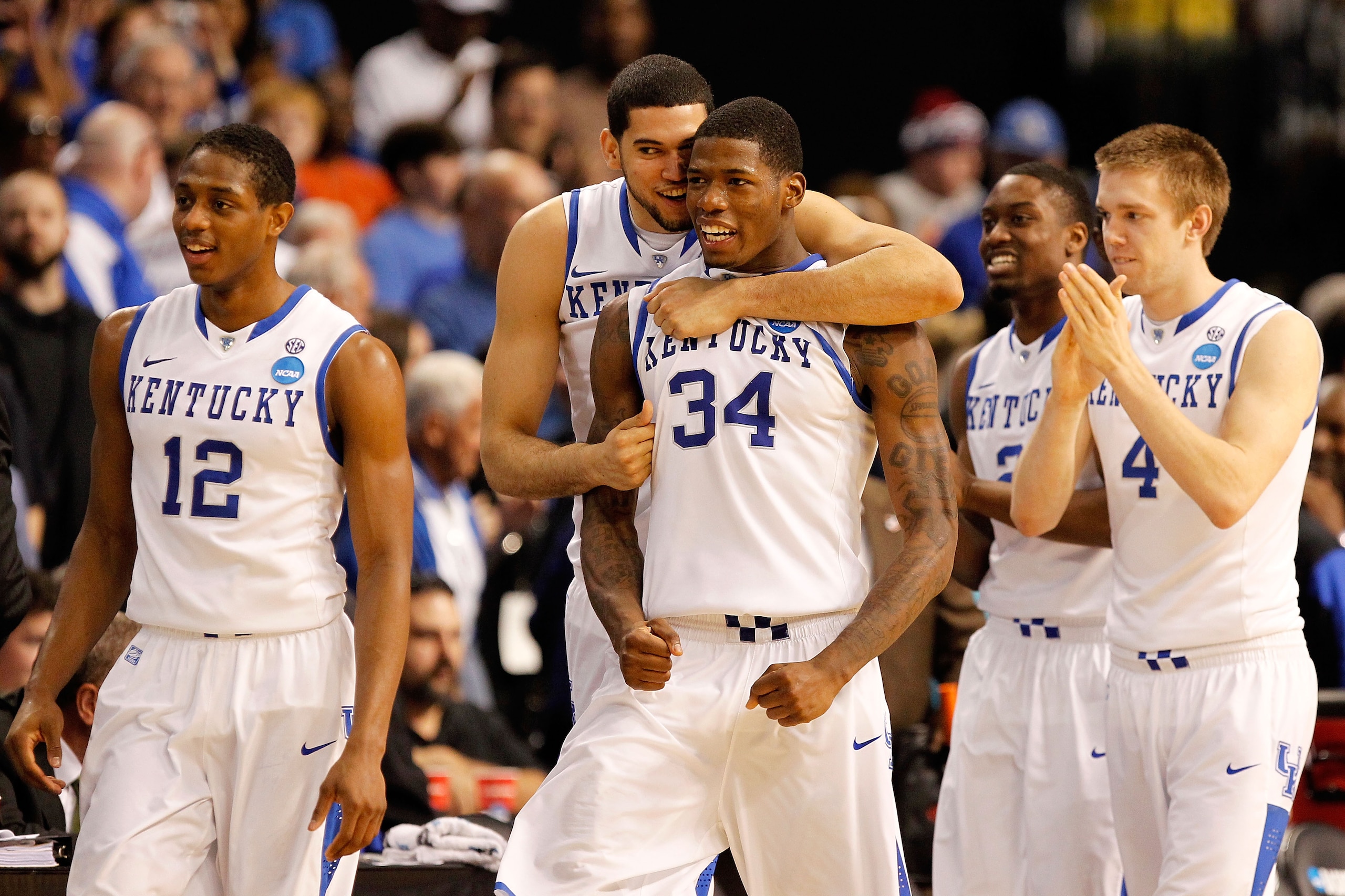 TAMPA, FL - MARCH 19:  Brandon Knight #12, Eloy Vargas #30, DeAndre Liggins #34, Stacey Poole Jr. #2 and Jon Hood #4 of the Kentucky Wildcats celebrate after they won 71-63 against the West Virginia Mountaineers during the third round of the 2011 NCAA men