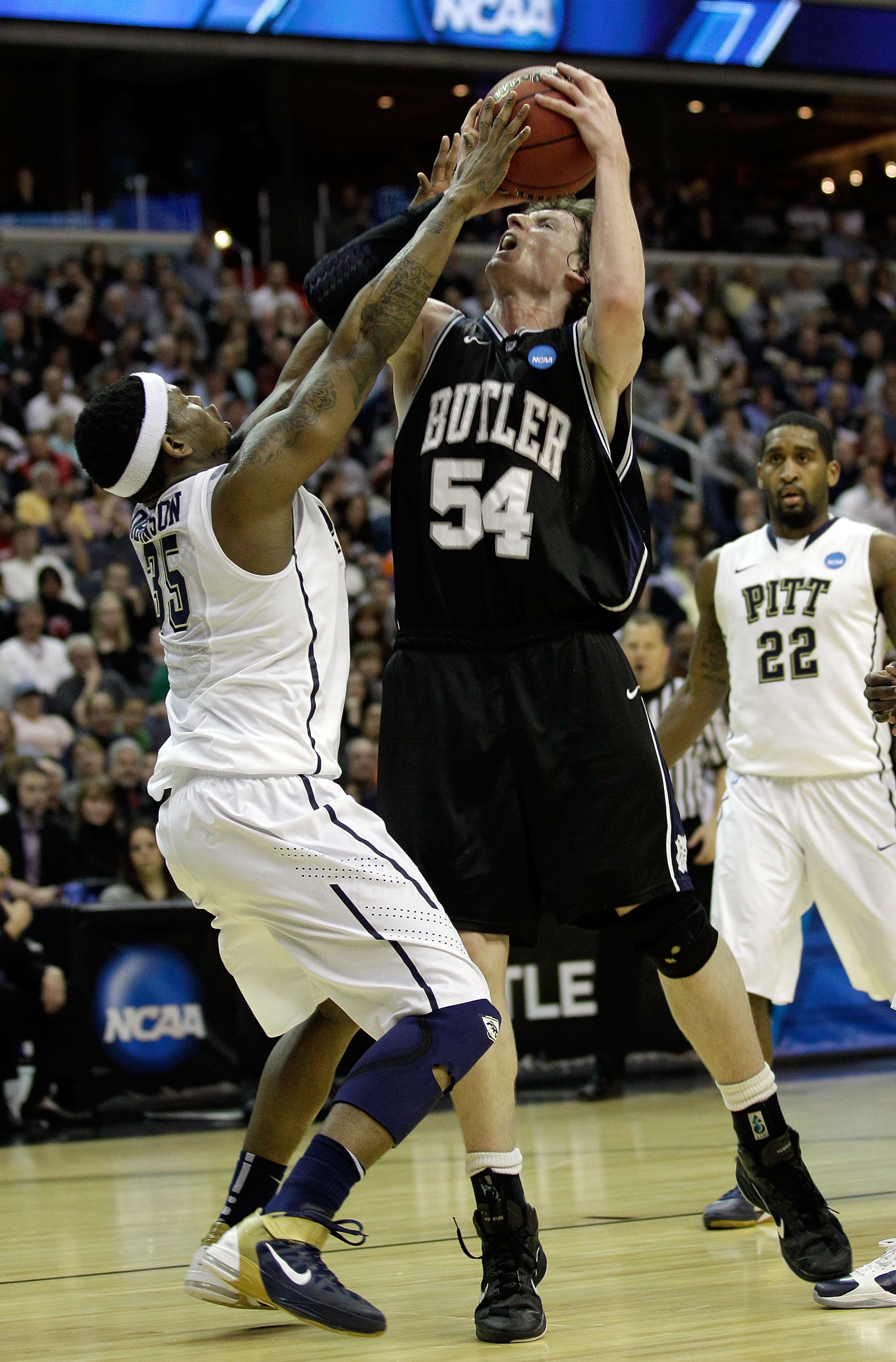 WASHINGTON - MARCH 19:  Matt Howard #54 of the Butler Bulldogs tries to put a shot over Nasir Robinson #35 of the Pittsburgh Panthers during the third round of the 2011 NCAA men's basketball tournament at Verizon Center on March 19, 2011 in Washington, DC