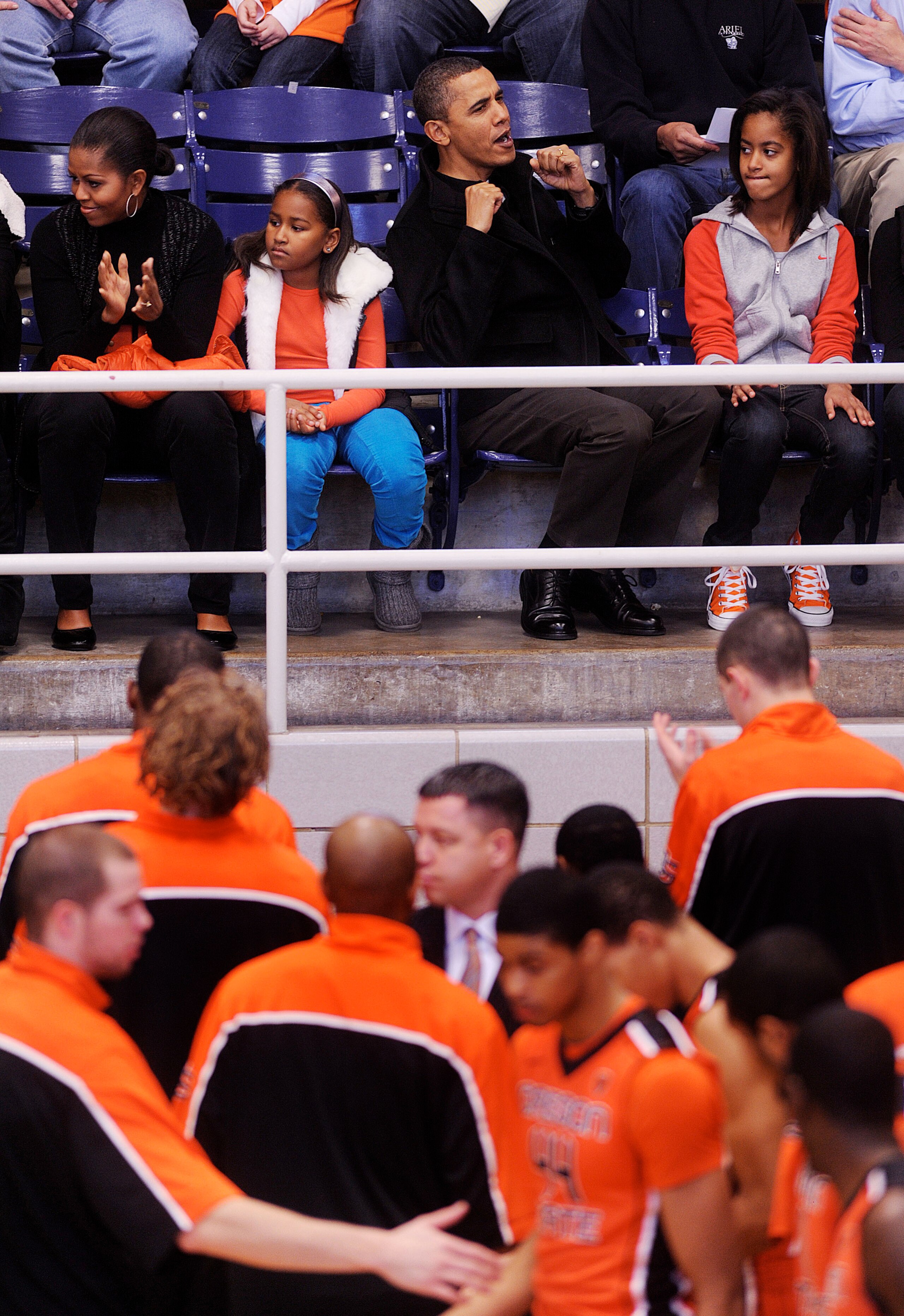 WASHINGTON - NOVEMBER 27:  (AFP OUT) U.S. President Barack Obama with his wife First Lady Michelle Obama  and daughters Malia and Sasha watches a college basketball game at Howard University November 27, 2010 in Washington, DC. President Barack Obama atte