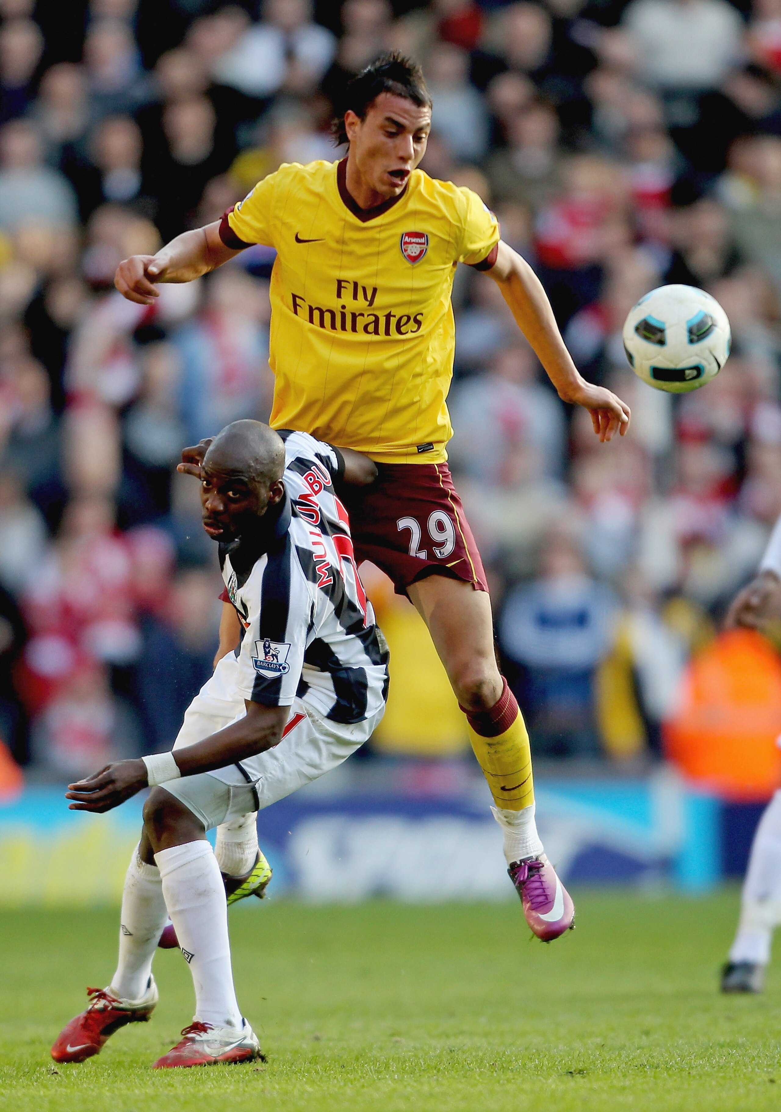 WEST BROMWICH, ENGLAND - MARCH 19: Youssouf Mulumbu of WBA (L) in action with Marouane Chamakh of Arsenal during the Barclays Premier League match between West Bromwich Albion and Arsenal at The Hawthorns on March 19, 2011 in West Bromwich, England. (Pho WEST BROMWICH, ENGLAND - MARCH 19: Youssouf Mulumbu of WBA (L) in action with Marouane Chamakh of Arsenal during the Barclays Premier League match between West Bromwich Albion and Arsenal at The Hawthorns on March 19, 2011 in West Bromwich, England. (Pho