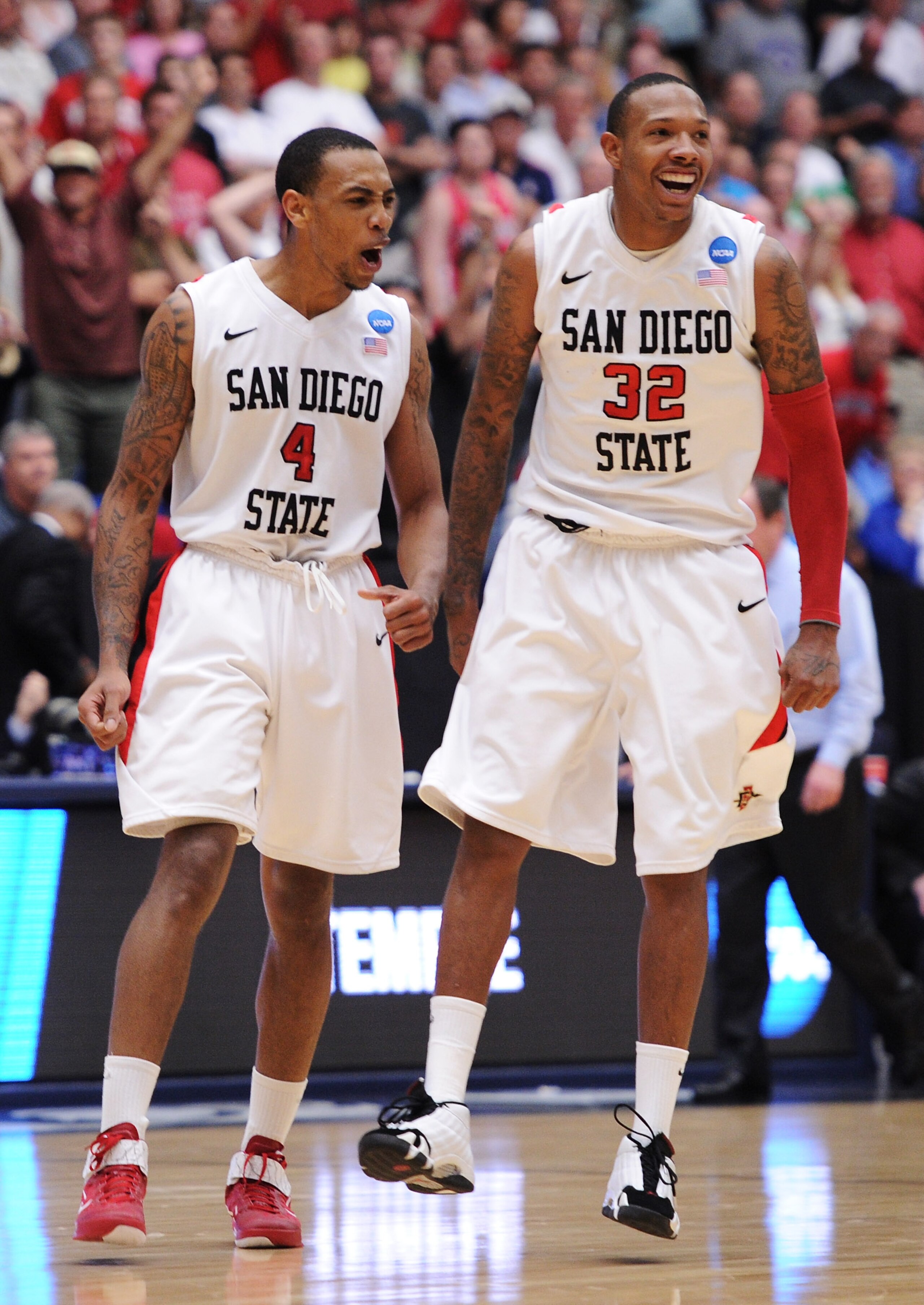 TUCSON, AZ - MARCH 19:  Malcolm Thomas #4 and Billy White #32 of the San Diego State Aztecs celebrate after defeating the Temple Owls 71 to 64 in double overtime during the third round of the 2011 NCAA men's basketball tournament at McKale Center on March