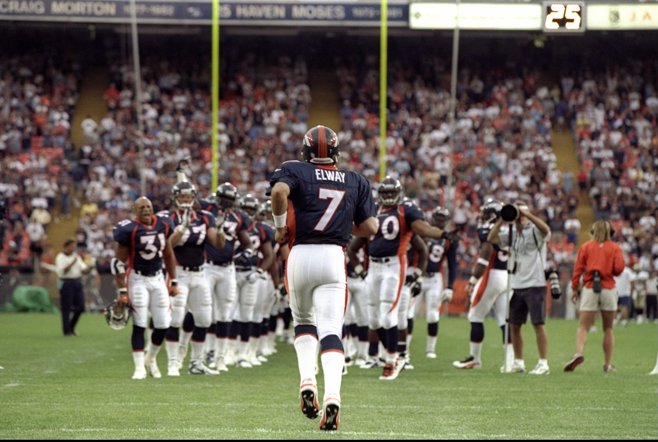 14 Aug 1998:  Quarterback John Elway #7 of the Denver Broncos runs on to the field prior to a pre-season game against the New Orleans Saints at the Mile High Stadium in Denver, Colorado. The Broncos defeated the Saints 17-10.