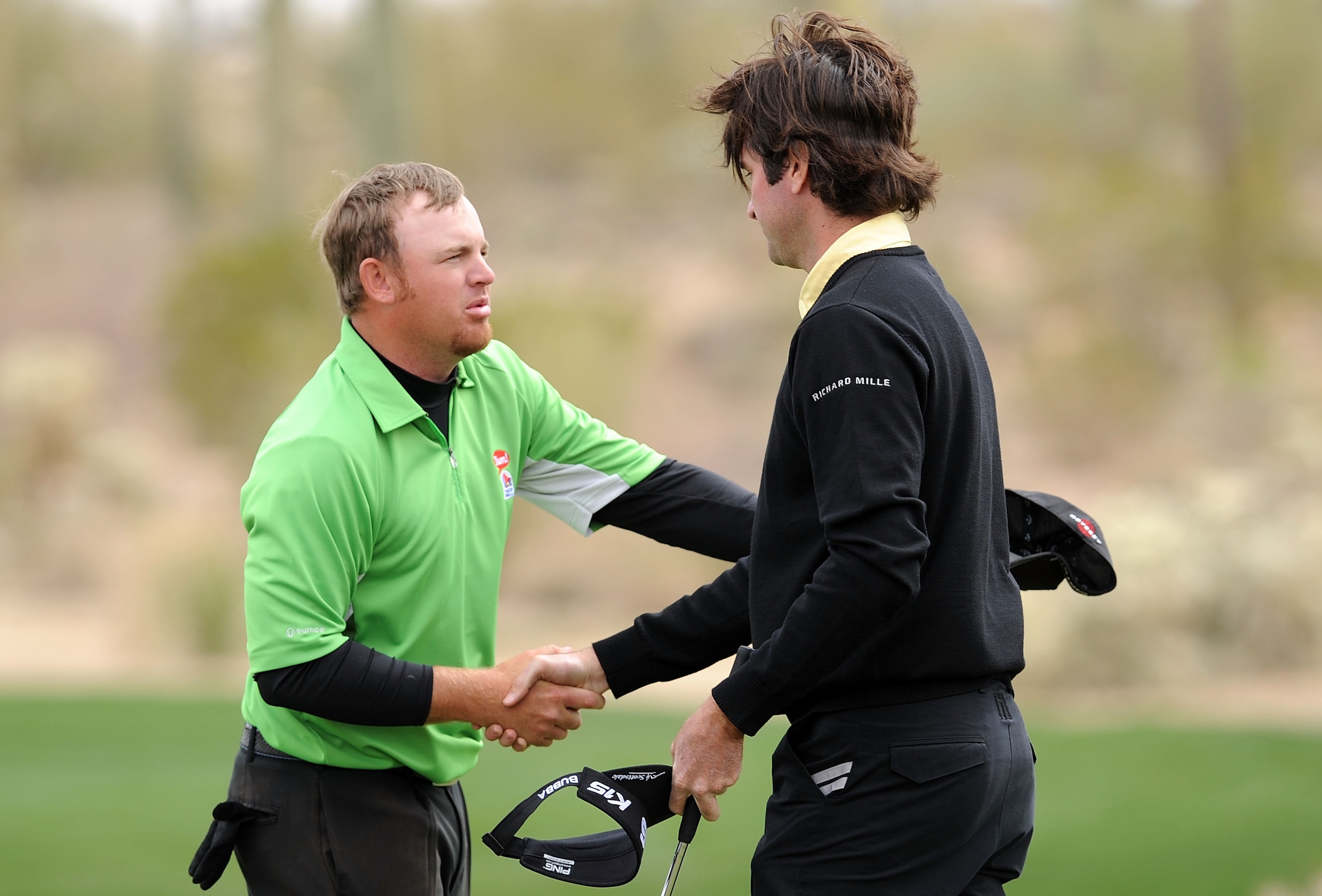 MARANA, AZ - FEBRUARY 26:  Bubba Watson shakes hands with J.B. Holmes on the first playoff hole during the quarterfinal round of the Accenture Match Play Championship at the Ritz-Carlton Golf Club on February 26, 2011 in Marana, Arizona.  (Photo by Stuart