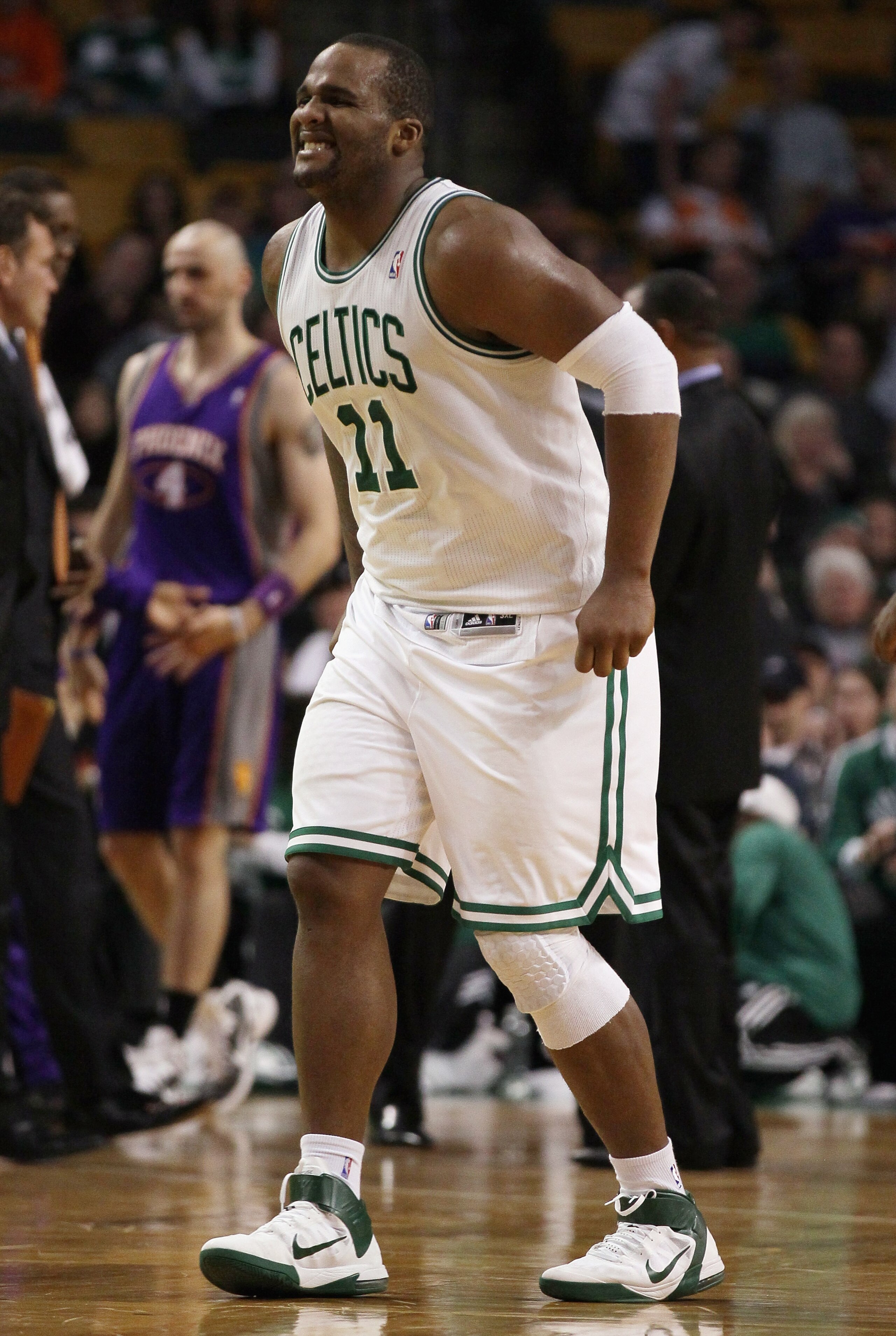 BOSTON, MA - MARCH 02:  Glen Davis #11 of the Boston Celtics winces in pain as he walks off the court in the fourth quarter against the Phoenix Suns on March 2, 2011 at the TD Garden in Boston, Massachusetts.  The Celtics defeated the Suns 115-103. NOTE T