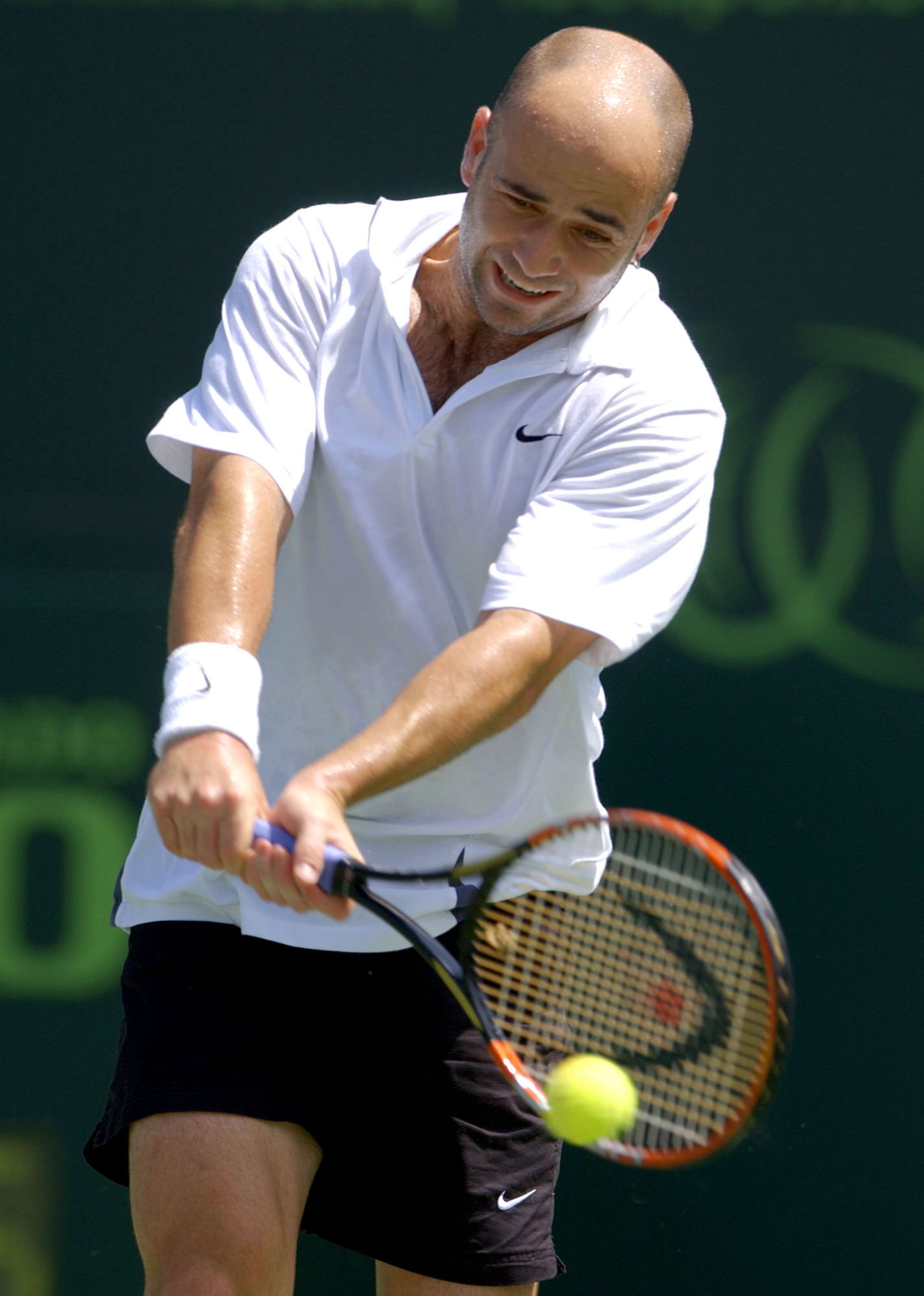 29 Mar 2002:  Andre Agassi returns a shot to Marcelo Rios of Chile during the Nasdaq-100 Open at The Tennis Center at Crandon Park in Miami, Florida. DIGITAL IMAGE Mandatory Credit: Ezra Shaw/Getty Images