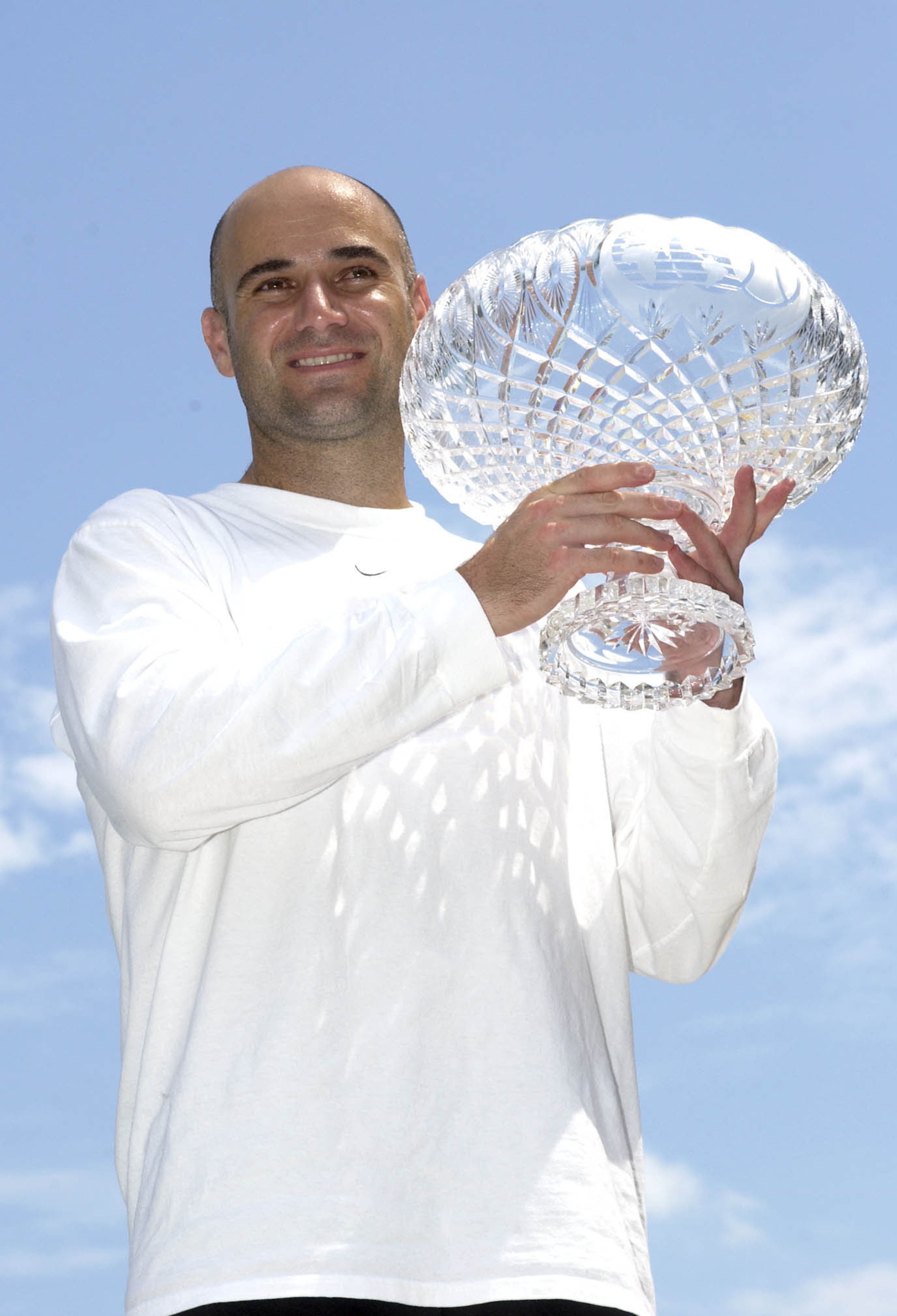 MIAMI - MARCH 30:  Andre Agassi poses for photographers at a photo session after the finals of the Nasdaq-100 Open on March 30, 2003 at the Tennis Center at Crandon Park in Miami, Florida.  Agassi defeated Carlos Moya 6-3, 6-3. (Photo by Ezra Shaw/Getty I