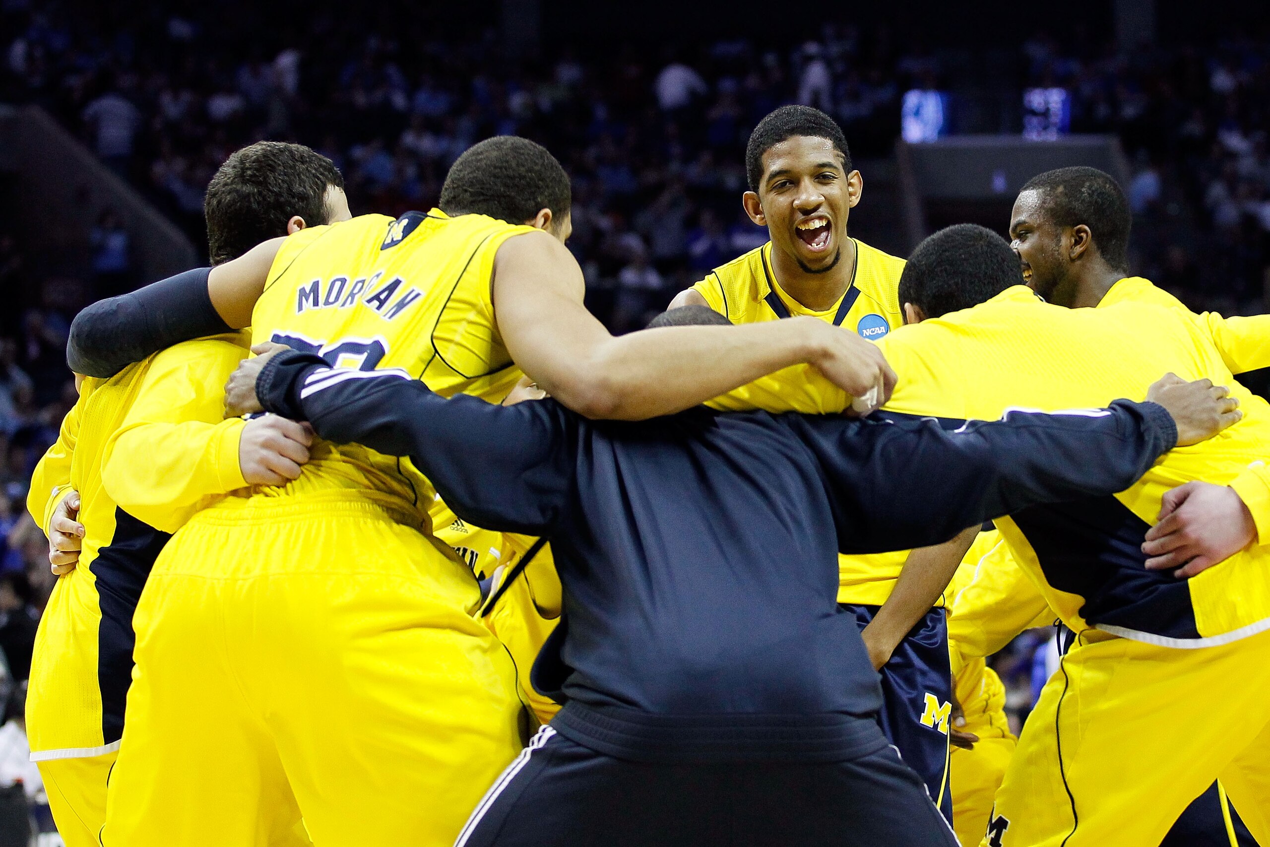 CHARLOTTE, NC - MARCH 20:  Darius Morris #4 of the Michigan Wolverines smiles as the Wolverines huddle before taking on the Duke Blue Devils during the third round of the 2011 NCAA men's basketball tournament at Time Warner Cable Arena on March 20, 2011 i
