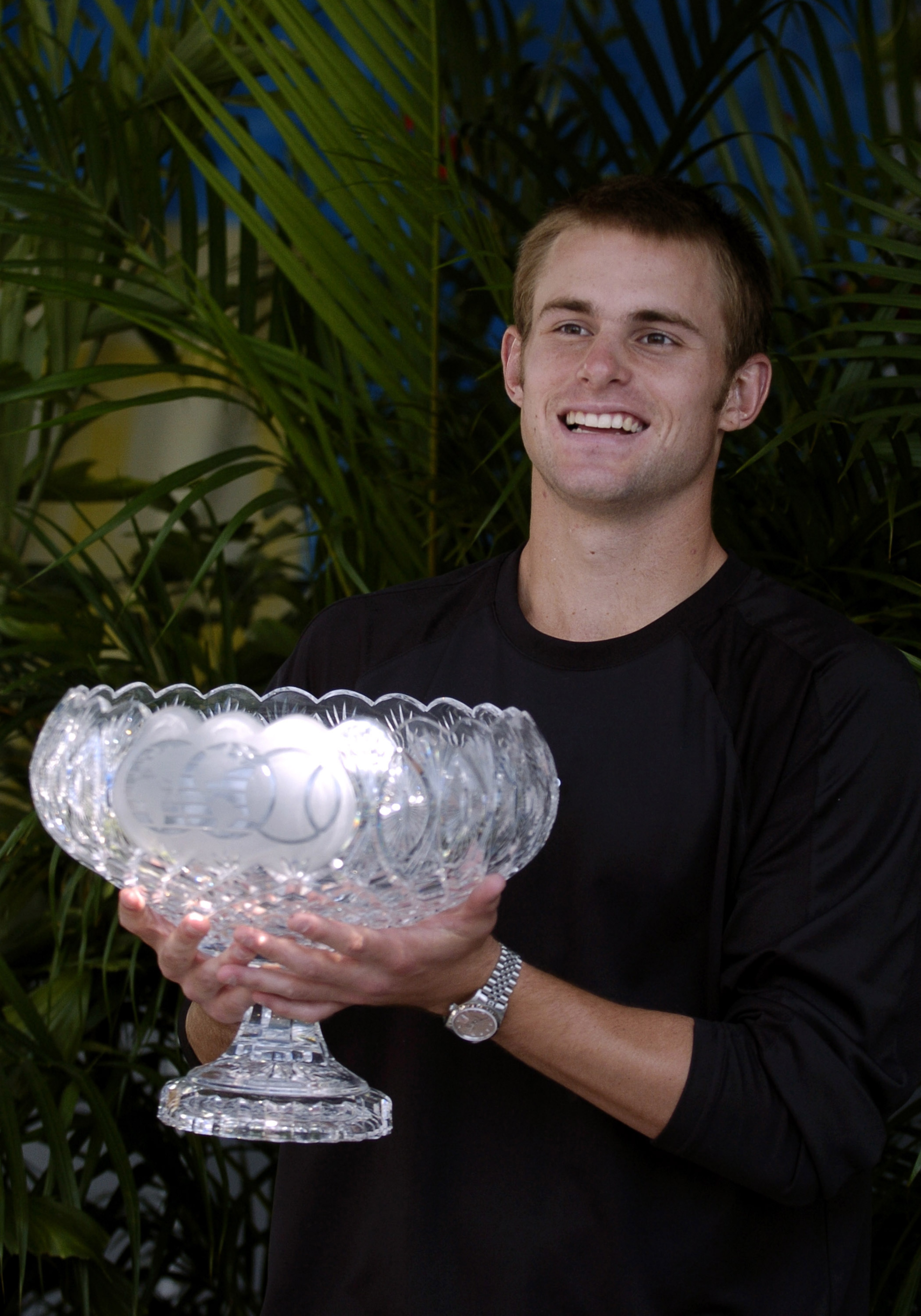 Andy Roddick  holds the winner's trophy   at  the NASDAQ 100 Open, April 4, 2004, Key Biscayne, Florida. (Photo by A. Messerschmidt/Getty Images)