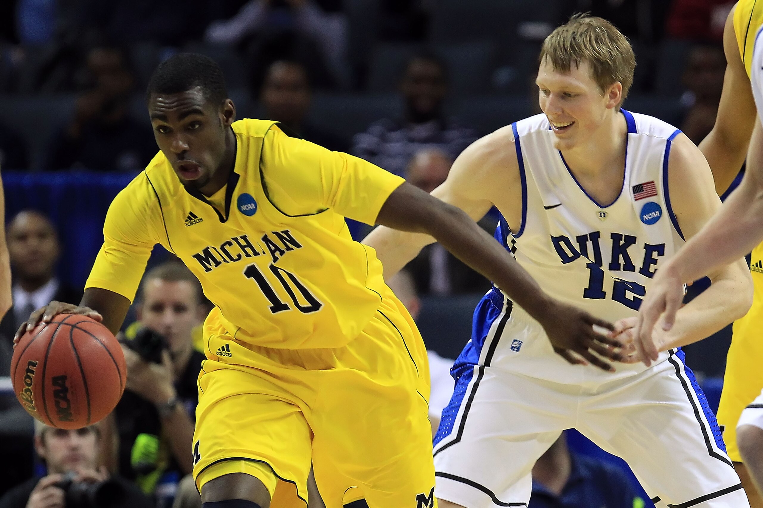 CHARLOTTE, NC - MARCH 20:  Tim Hardaway Jr. #10 of the Michigan Wolverines moves the ball against Kyle Singler #12 of the Duke Blue Devils in the first half during the third round of the 2011 NCAA men's basketball tournament at Time Warner Cable Arena on