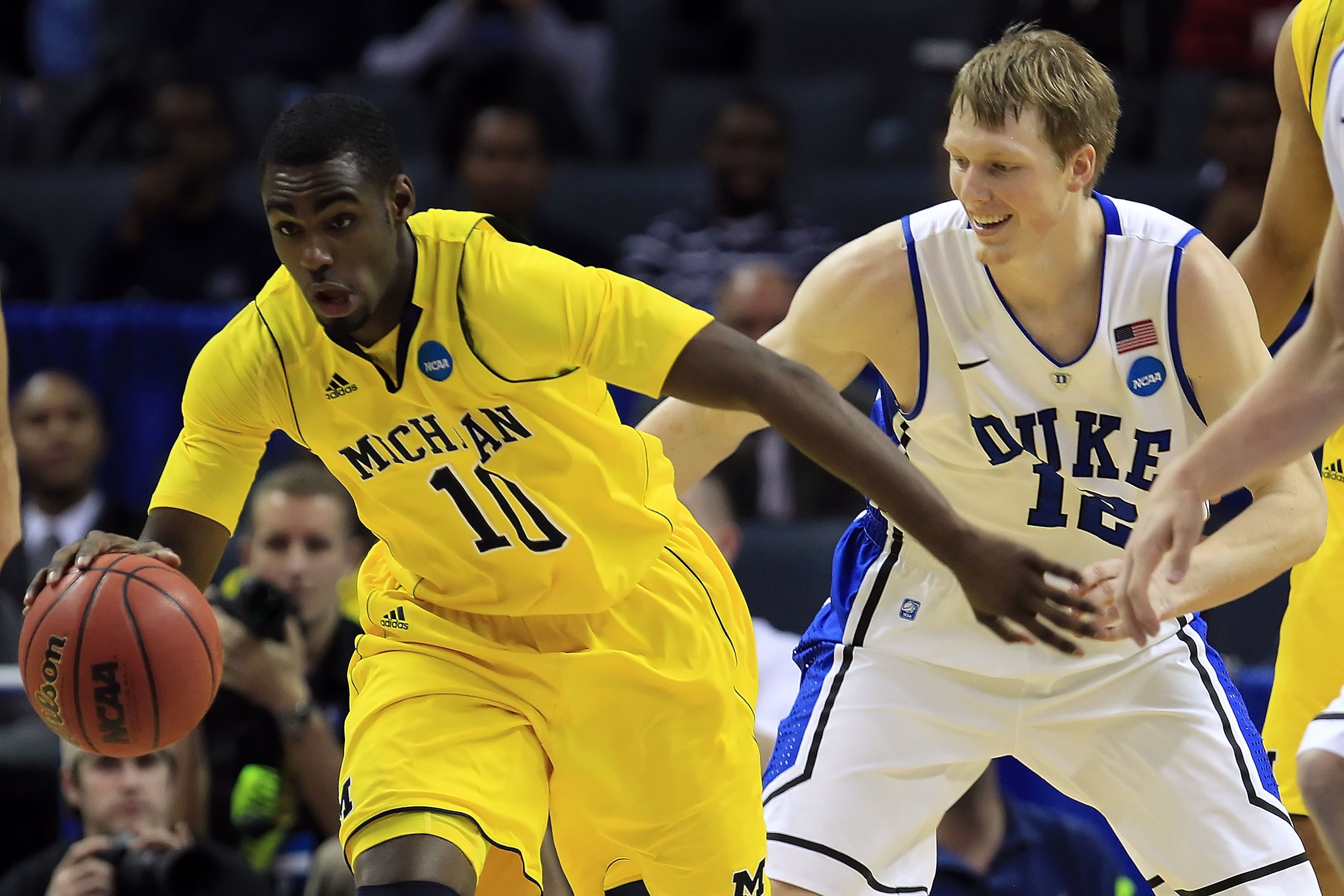 CHARLOTTE, NC - MARCH 20:  Tim Hardaway Jr. #10 of the Michigan Wolverines moves the ball against Kyle Singler #12 of the Duke Blue Devils in the first half during the third round of the 2011 NCAA men's basketball tournament at Time Warner Cable Arena on