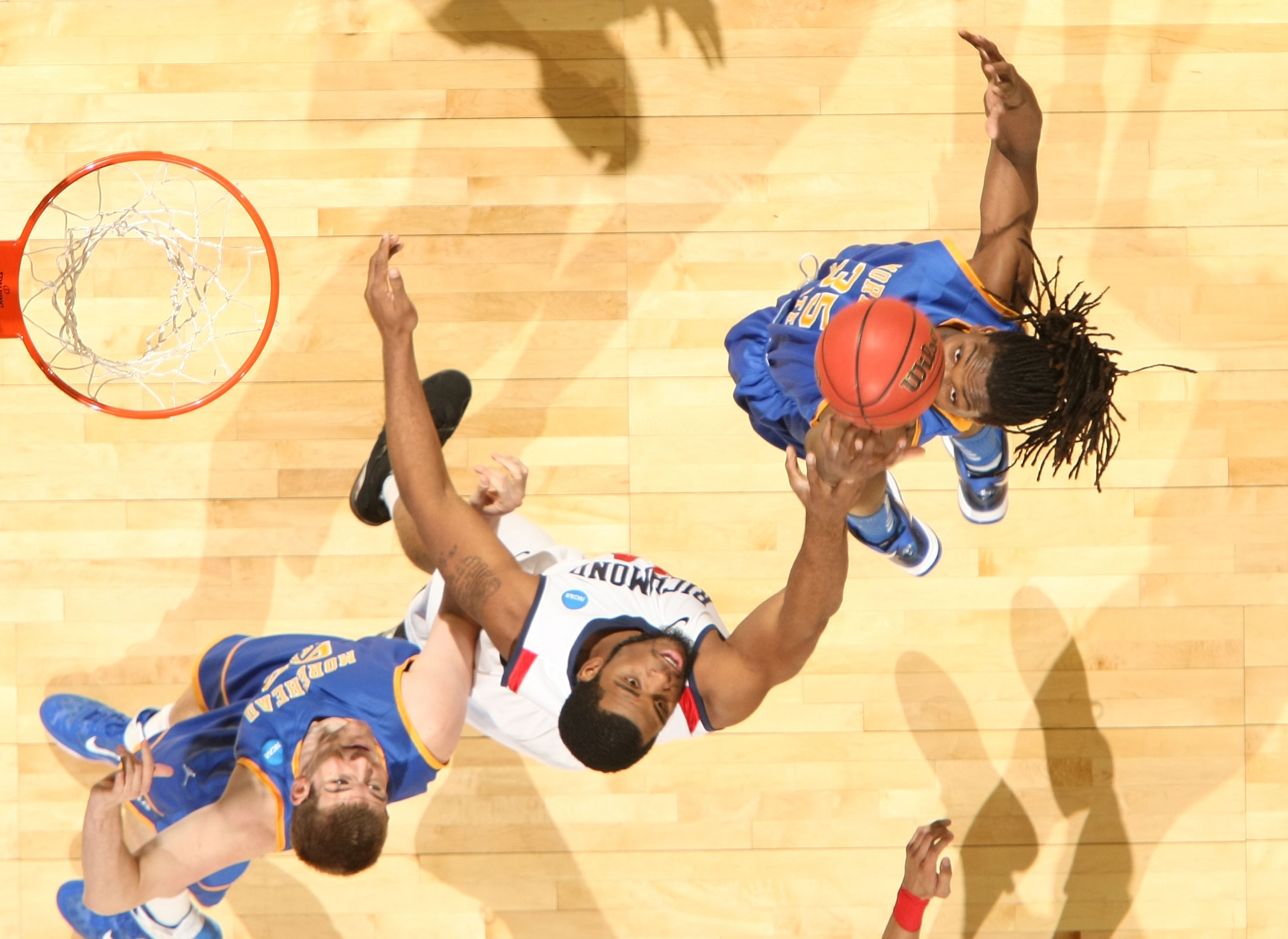 DENVER, CO - MARCH 19:  Kenneth Faried #35 and Drew Kelly #00 of the Morehead State Eagles fight for a rebound against Derrick Williams #34 of the Richmond Spiders during the third round of the 2011 NCAA men's basketball tournament at Pepsi Center on Marc