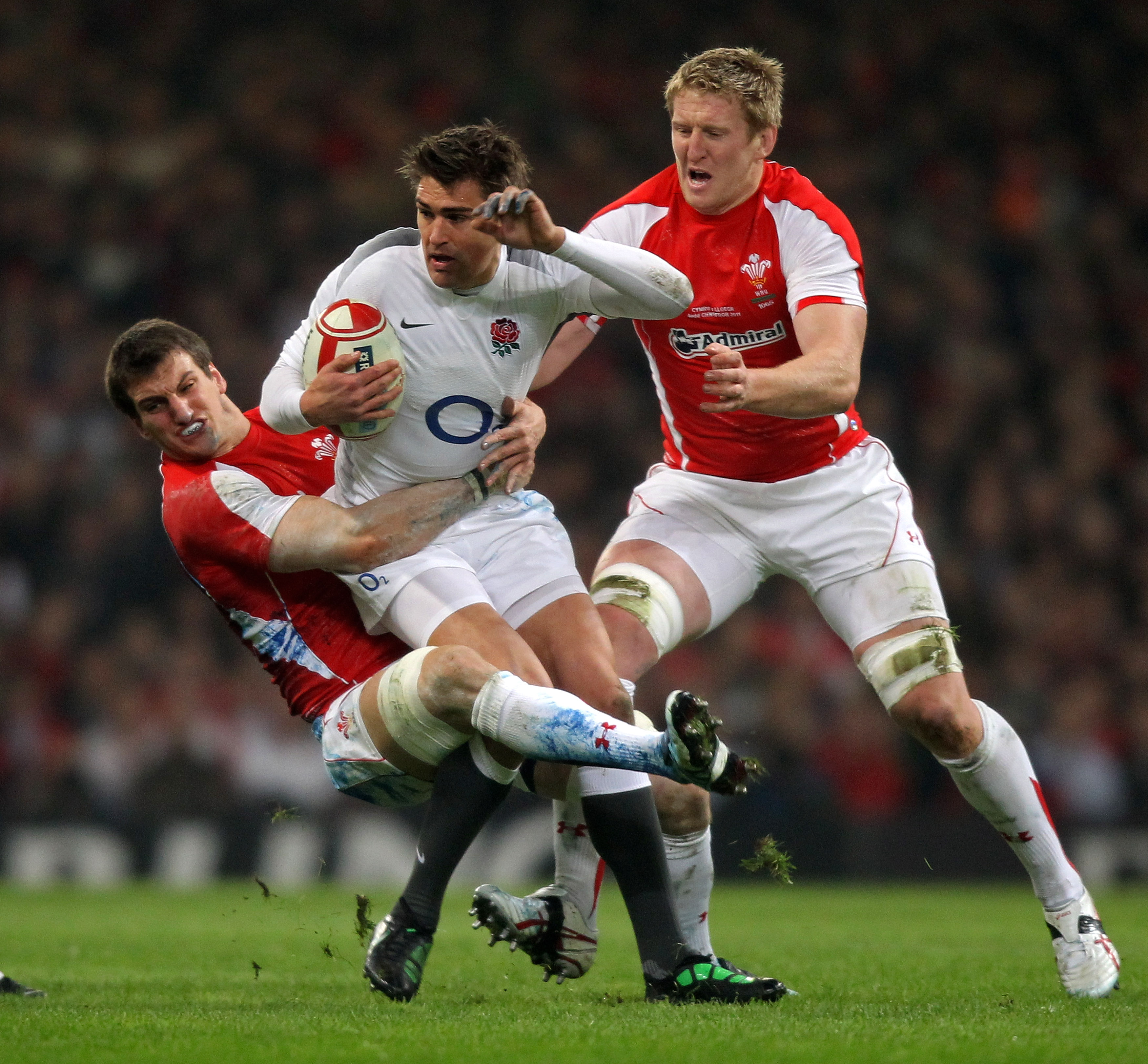 CARDIFF, WALES - FEBRUARY 04:  Toby Flood of England is tackled by Sam Warburton (L) and Bradley Davies (R) of Wales during the RBS 6 Nations Championship match between Wales and England at the Millennium Stadium on February 4, 2011 in Cardiff, Wales.  (P