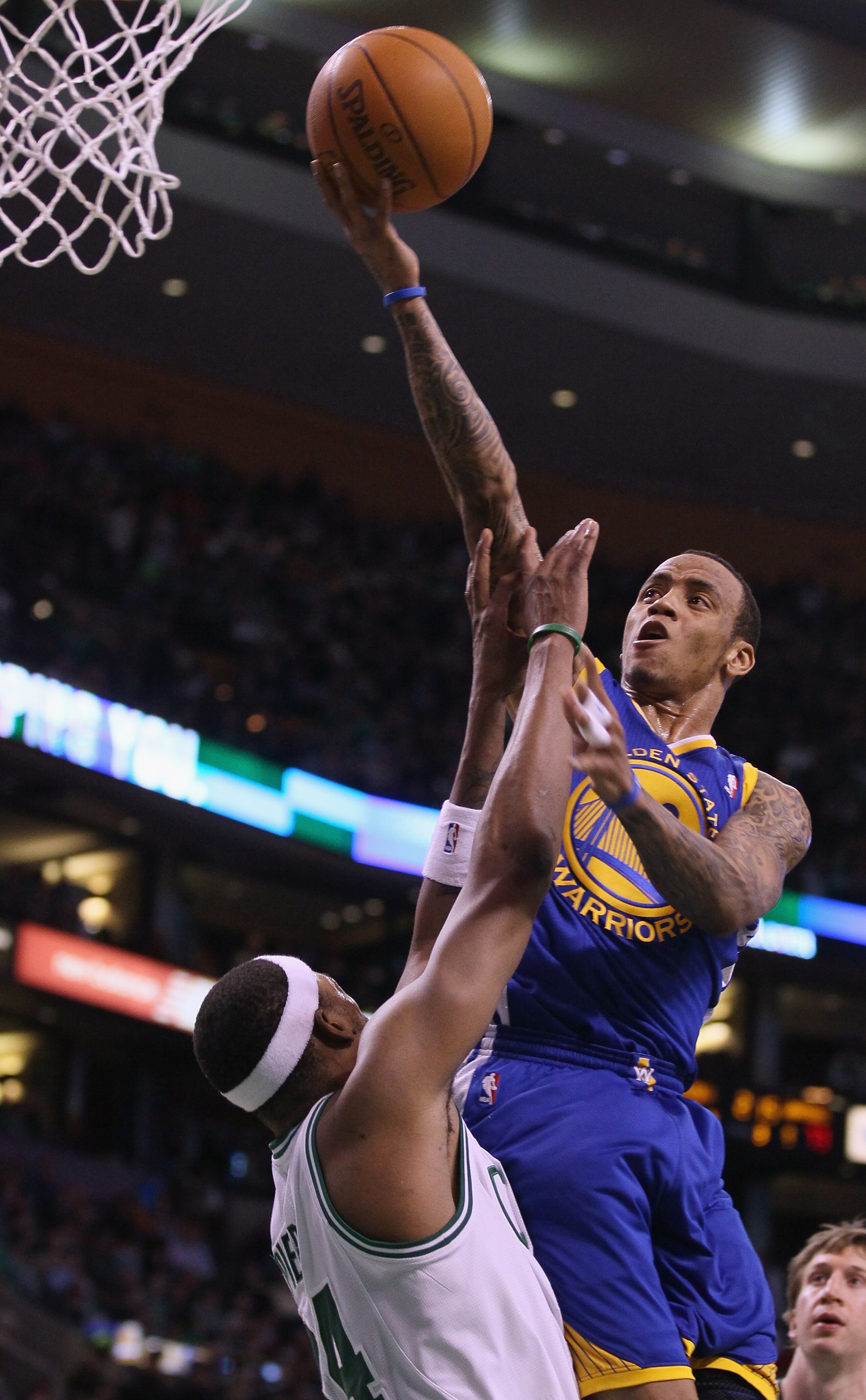 BOSTON, MA - MARCH 04:  Monta Ellis #8 of the Golden State Warriors takes a shot over Paul Pierce #34 of the Boston Celtics on March 4, 2011 at the TD Garden in Boston, Massachusetts.  The Celtics defeated the Warriors 107-103. NOTE TO USER: User expressl