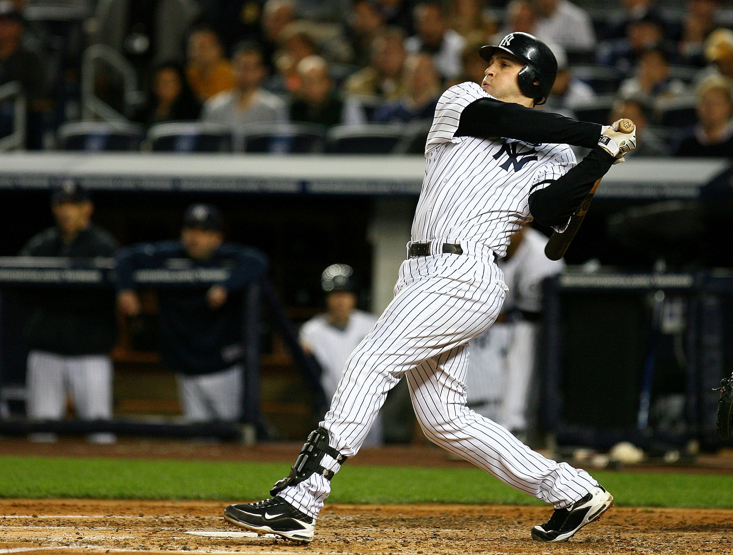 NEW YORK - OCTOBER 09:  Mark Teixeira #25 of the New York Yankees hits a RBI single in the bottom of the third inning against the Minnesota Twins during Game Three of the ALDS part of the 2010 MLB Playoffs at Yankee Stadium on October 9, 2010 in the Bronx