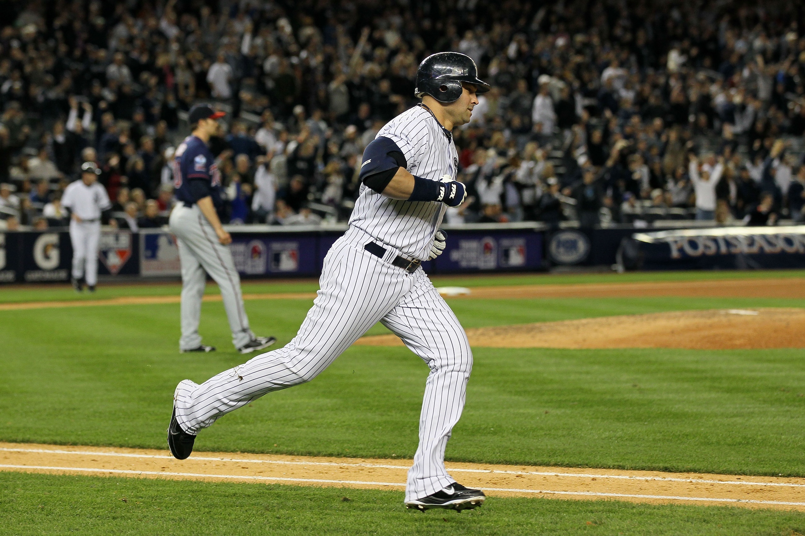NEW YORK - OCTOBER 09:  Nick Swisher #33 of the New York Yankees runs the bases on his solo home run in the bottom of the seventh inning against the Minnesota Twins during Game Three of the ALDS part of the 2010 MLB Playoffs at Yankee Stadium on October 9