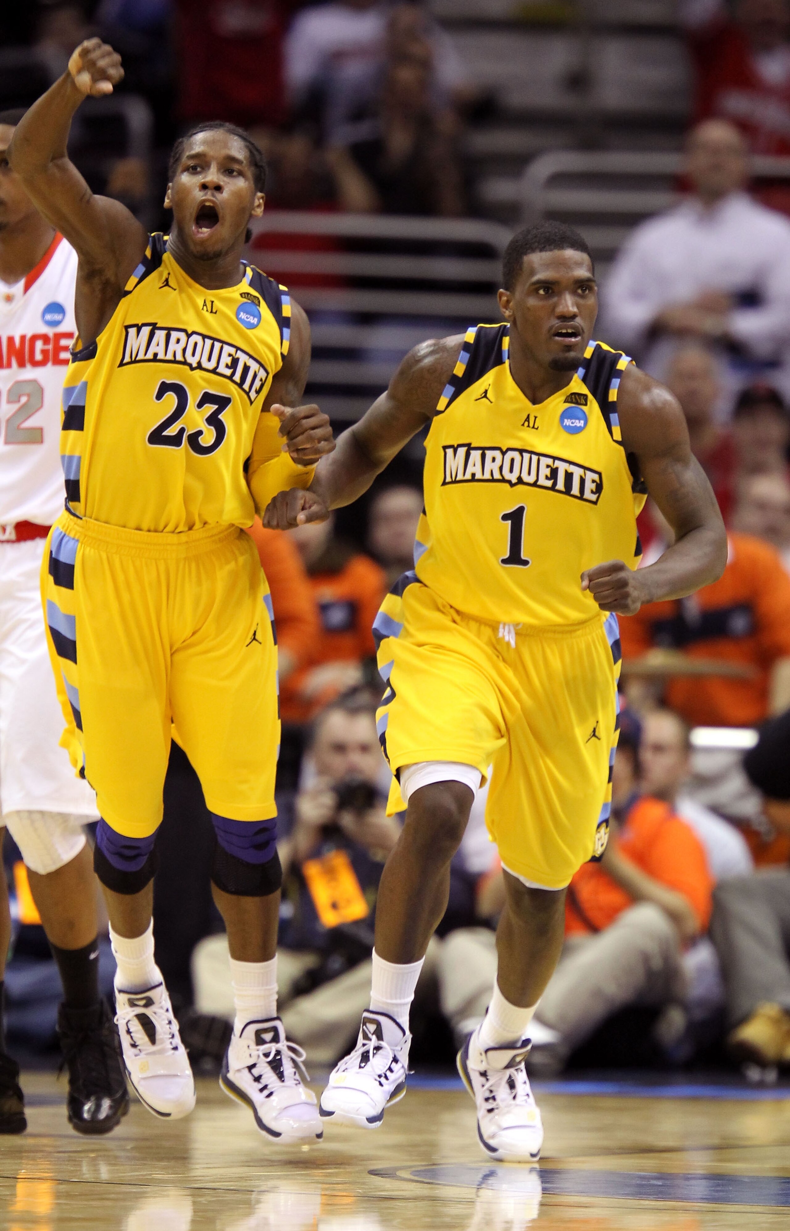 CLEVELAND, OH - MARCH 20: Dwight Buycks #23 and Darius Johnson-Odom #1 of the Marquette Golden Eagles celebrate late in the game against the Syracuse Orange during the third of the 2011 NCAA men's basketball tournament at Quicken Loans Arena on March 20,