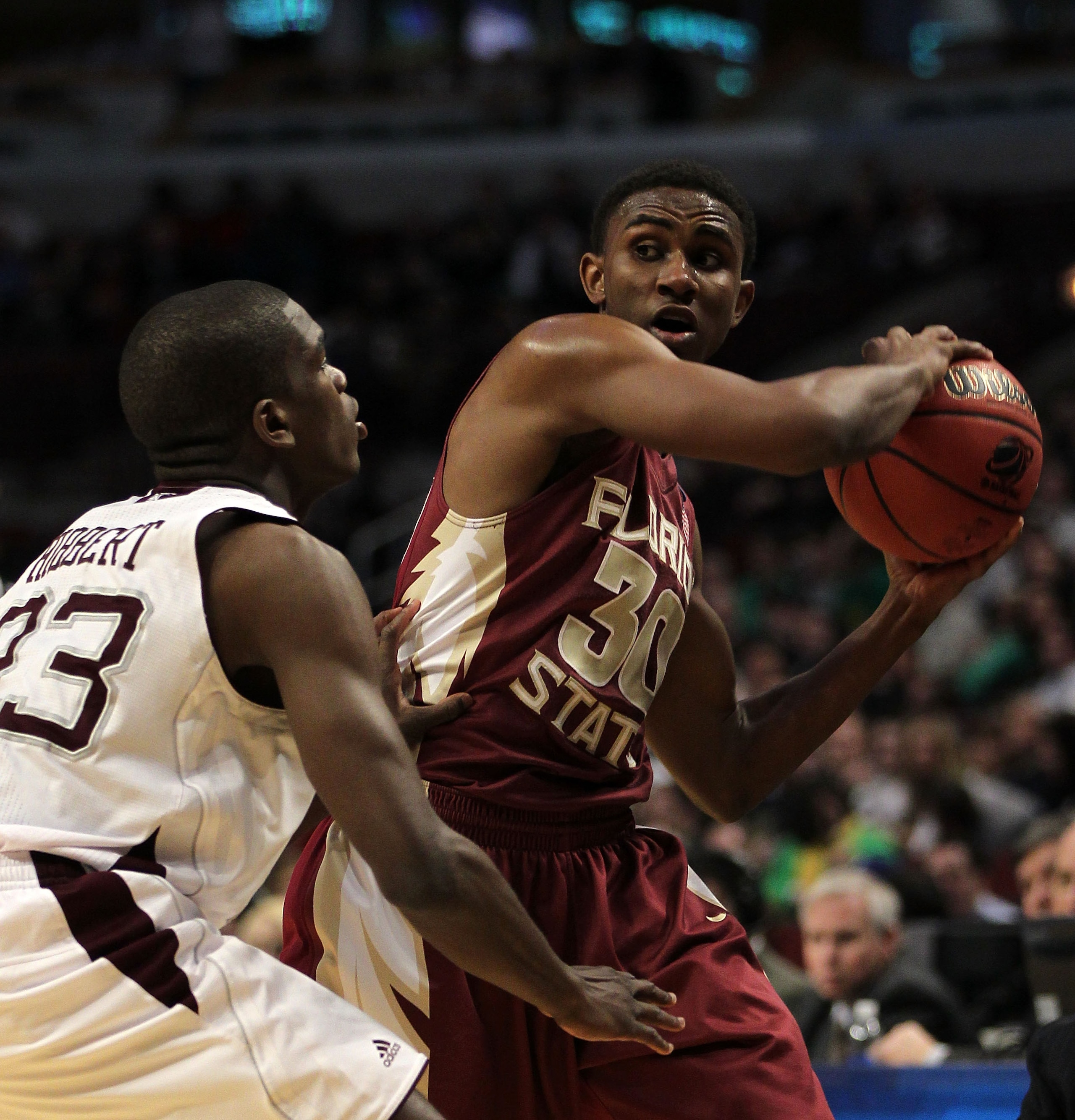 CHICAGO, IL - MARCH 18:  Ian Miller #30 of the Florida State Seminoles looks to pass against Naji Hibbert #23 of the Texas A&M Aggies in the first half during the second round of the 2011 NCAA men's basketball tournament at the United Center on March 18,